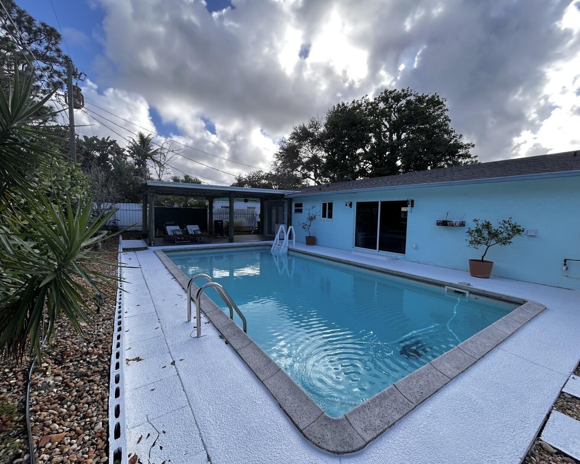 Remodel 4 Bed/3 bath home located on a quiet Cul-de-sac, few minutes away to the beach & to historic downtown Stuart!  Don't miss your opportunity to own a property that offers both a beautiful living space and the opportunity for rental income. The standout feature of this home is the garage conversion to a private 1bed/1 bath & living room/ In-Law suite apartment with a separate entrance. The generous size & fully fenced outdoor space offers a heated pool & a covered gazebo patio perfect for lounging and entertaining.  Step inside the home to discover a clean and bright open-concept layout.  Concrete block construction, 2024 roof, new foam insulation, beautiful landscape, storage shed, indoor laundry room, Impact windows(partial), No HOA. This is an amazing home!