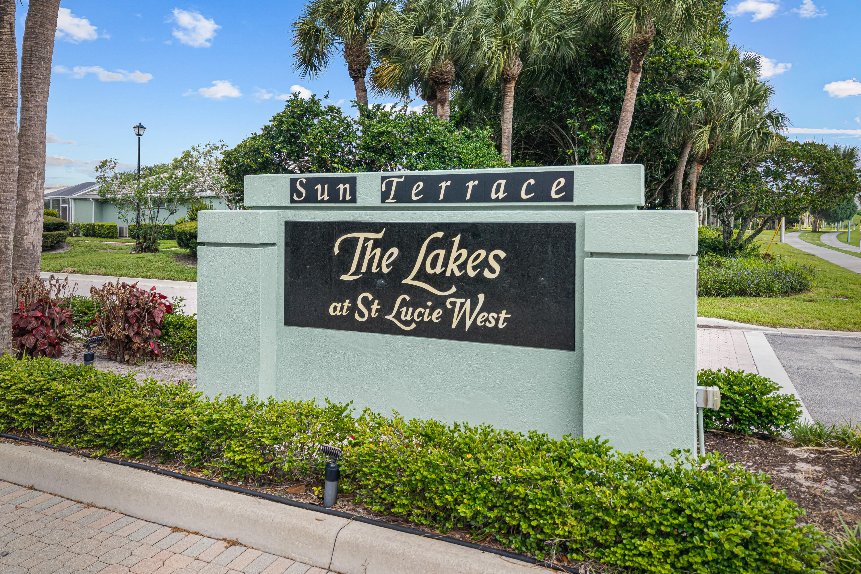 Sun Terrace at the Lakes at St. Lucie West - 2 bedroom, 2 bath Villa in Desirable St. Lucie West. Villa has an ***Open Floor Plan*** KItchen opens up to the Living/Dining Area. Mirrored Closet Doors in Bedrooms with built-in shelves. Tile in Kitchen and Bathrooms, Laminate Flooring everywhere else. Kitchen has SS Appliances & LED Lighting. Huge screened Courtyard creates additional living space to enjoy the private garden view and large yard space.   A/C replaced 08/2020. Sun Terrace is within walking distance to Publix, Restaurants, Banks & LA Fitness.