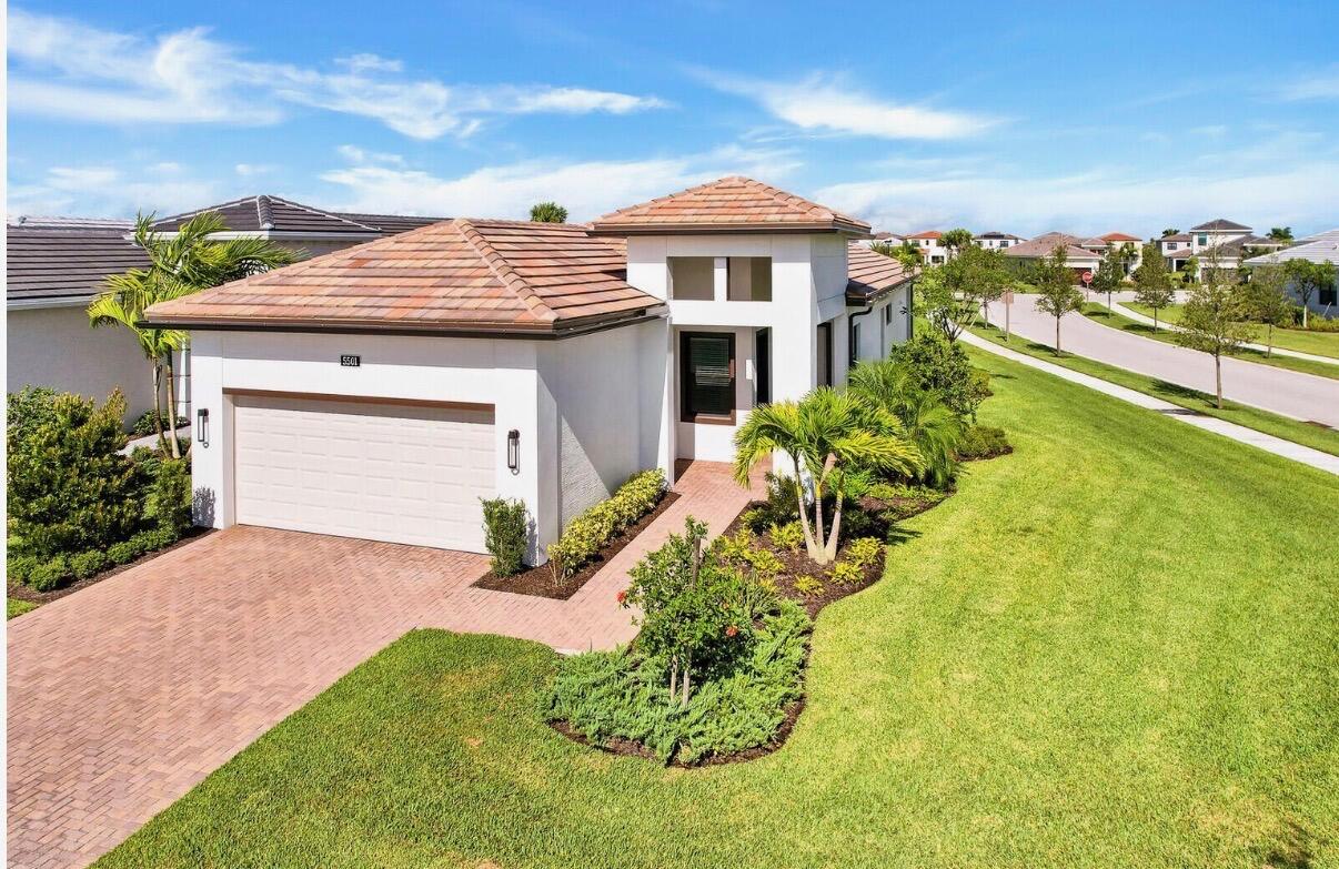 This luxurious 3-bedroom, 2-bathroom home in Cresswind at Westlake features an open floor plan and a kitchen perfect for cooking and entertaining, with white cabinetry, quartz countertops, and stainless steel appliances. This home also features impact glass, a covered patio, and a garden view, adding protection and outdoor enjoyment. Located in the vibrant Westlake community, residents enjoy resort-style amenities including pools, a fitness center, clubhouse, sports courts, playgrounds, and more. This home offers a fun, easygoing lifestyle in one of South Florida's most exciting communities, complete with countless amenities! ACTIVE ADULT COMMUNITY.