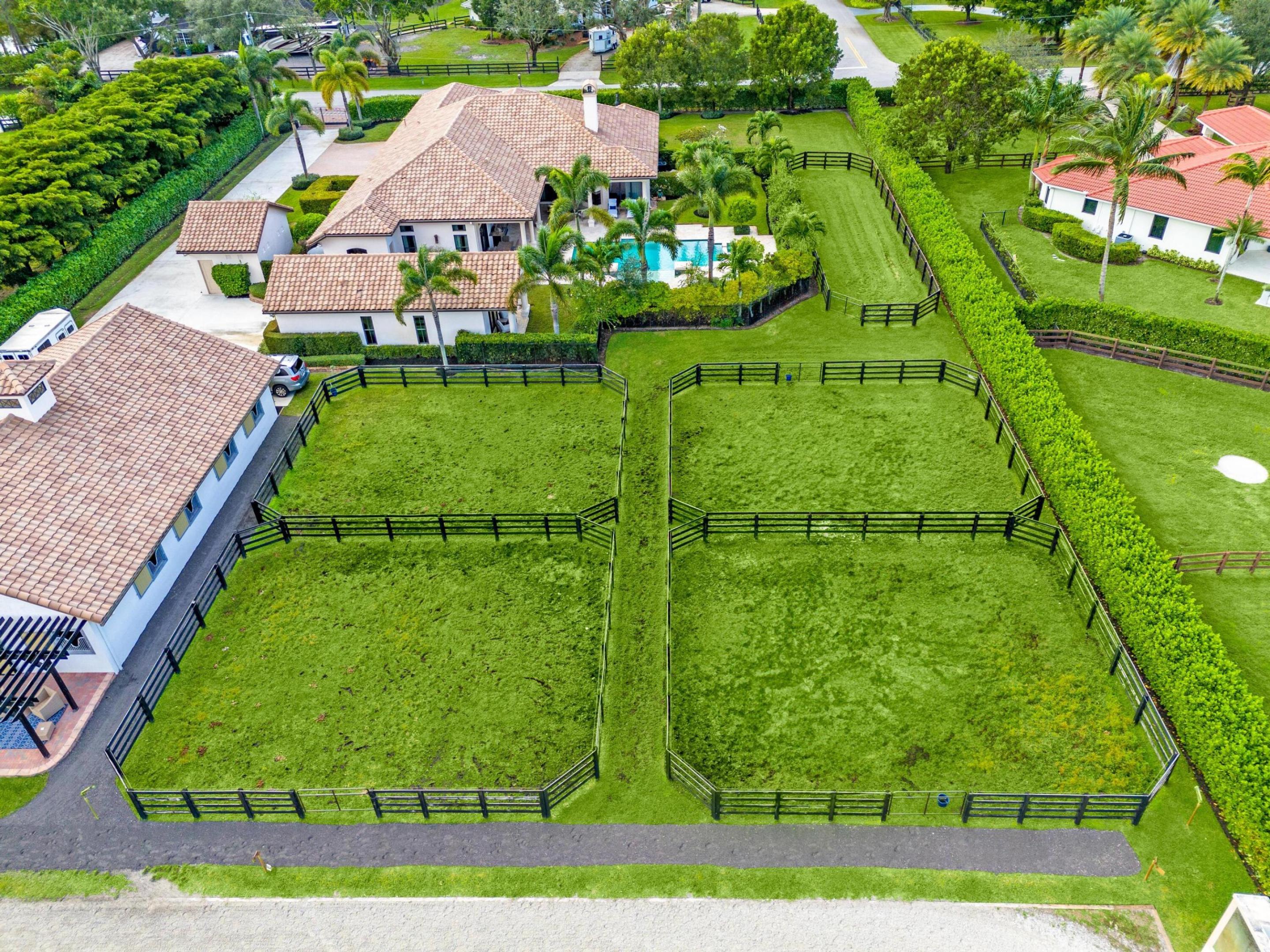 This stunning 5,787 sq ft estate, set on 1.7 acres, is the perfect blend of modern luxury w/world-class equestrian facilities. The property features a beautiful 5-stall center-aisle barn, complete with a tack room/lounge, kitchenette, half bath, and laundry room, as well as a 185' x 80' mirrored dressage arena, 5 paddocks, & ample storage. The expansive main residence, built in 2014, offers 4 bedrooms, 4.1 baths, and a private office. It boasts impact windows & doors, a gourmet kitchen with a center island, and a spacious primary suite with a fireplace and direct access to the resort-style pool and patio. The backyard oasis includes a heated pool & spa with marble decking, a summer kitchen, and a gas fireplace, perfect for entertaining, surrounded by lush greenspace and complete privacy. The property also includes a 3-car garage.
A 1-bedroom, 1-bath guest house (874 sq ft) with a full kitchen, living room, and washer/dryer offers privacy and comfort for guests. Recent upgrades include a new AC, reverse osmosis water system, pool equipment, and a state-of-the-art security system with Sonos audio throughout.
This unparalleled estate offers the ultimate haven for both you and your horses, with the finest amenities just minutes from Wellington's renowned horse show venues, shopping, and dining.
Don't miss the opportunity to experience this extraordinary propertyschedule your private tour today!

Propane gas runs the generator, pool heater, grill and fire places
The pool is a salt system

Whats new 
1 new AC unit in main house -2023 - units serviced 3x per year 
new ice machine -2024
Whole home water system - newly updated reverse osmosis water system 2023 and 2024
Pool waterfall
New lighting system - pool 
New pool heat element - 2024
Pool serviced weekly 
New irrigation pump 2023
Sprinkle panel / timer 
New pool pump 2023
Hikvision gate access pad and camera - 2022
New gate motor system -2024
New whole home 5g wifi - Luma - 2023
New Luma video / security system barn and home -13 cameras -8mp - 2023
Alarm security system -2023
Nest video door bell -2022
New nest fire detectors - 2023
Sonos system -2021
Replacement of various sprinkler heads throughout yard 
New driveway extension and grading of swell (permit still open) -2024
Newly added pergolas off barn with interlocking pavers -2024
New oven in guest house -2023
New door on manure garage -2024
Replaced 2 stall fans - 2024 
Wall unit in office -2024
Septics both pumped in - 2022
All furniture new in - 2022
New fridge in barn - 2024
Sealing of stone surrounding pool - 2024