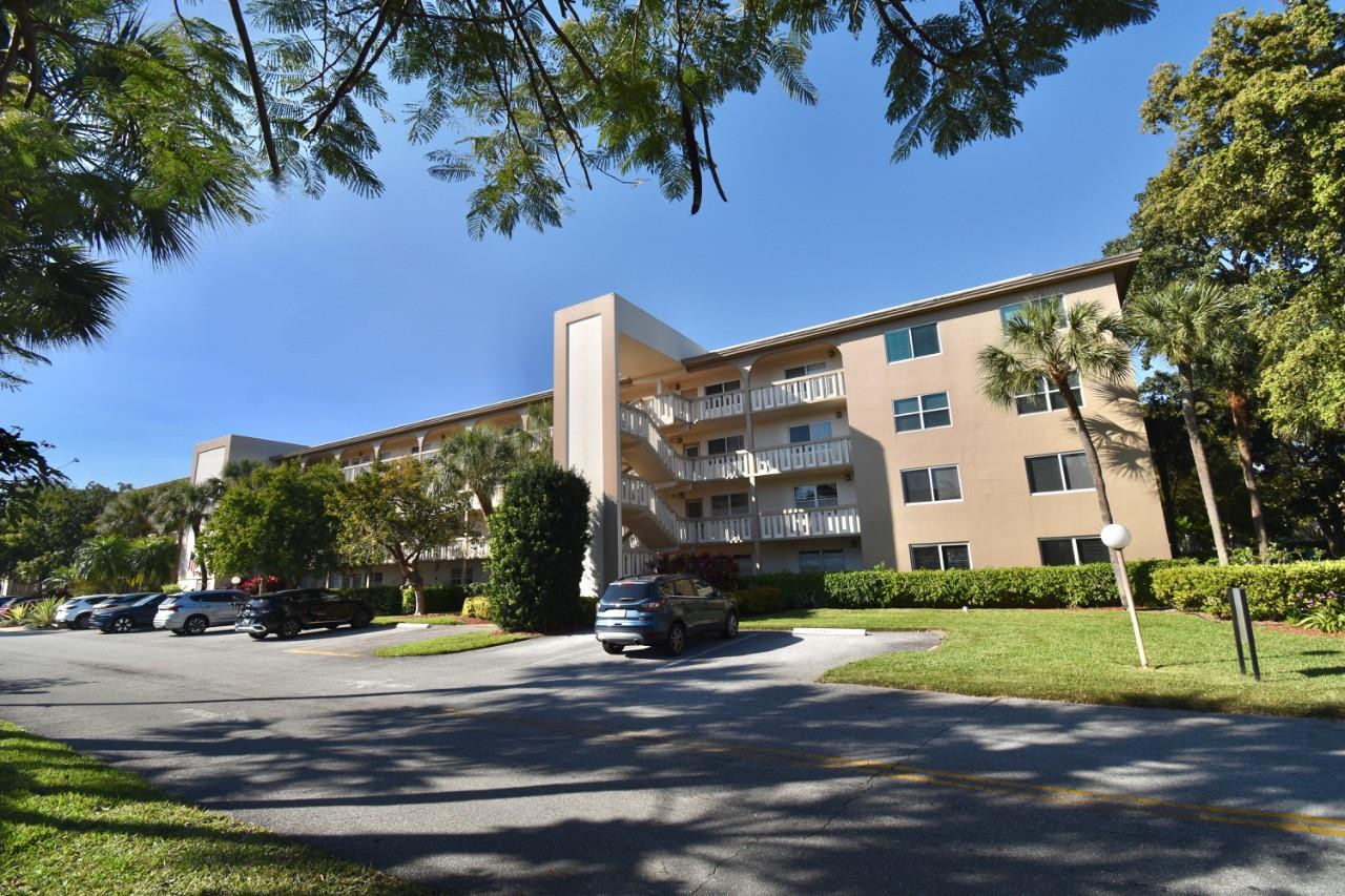 Beautifully remodeled 55+ first floor condo with breathtaking panoramic lake views! The open entry leads to the kitchen with custom cabinets, granite countertops, and stainless steel appliances. Features include 14" diagonal porcelain tile and wood laminate flooring, remodeled bathrooms, a walk-in shower in the guest bath, and a walk-in closet. THE IMPACT GLASS ENCLOSED LANAI is RAISED and has NEW WINDOWS with no direct sun exposure. Additional upgrades: 5-year-old A/C and roof, newer water heater, Kirsch blinds, and freshly painted interior. Parking by stairs and full-size storage unit included. Walk to the theater, fitness center, jacuzzi, lazy river, main pool, BBQ area, and on-site restaurant. HOA covers water and cable. Ideally located near all essentials for easy living!