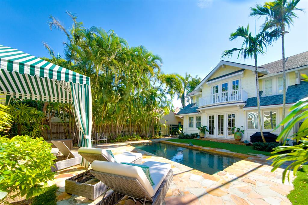 This center of town prime location beach house has been completely reimagined and is ready for immediate move in. Easy living in the main house while your guests enjoy the like new guest house complete with a kitchen, laundry, 2 bedrooms and a bath. Natural light fills the home throughout with beautiful new Impact glass windows and doors.  Each bedroom has en suite baths and  large closets. The Kitchen, open to the family room and pool,  is complete with custom cabinets, granite counter tops, and Wolf gas range. All of this on a deep lot with a tropical pool and garden separating the main house from the guest house. Walk to restaurants, beaches, Brazilian docks, dog park, lake trail, the Brazilian Court and Worth Avenue!