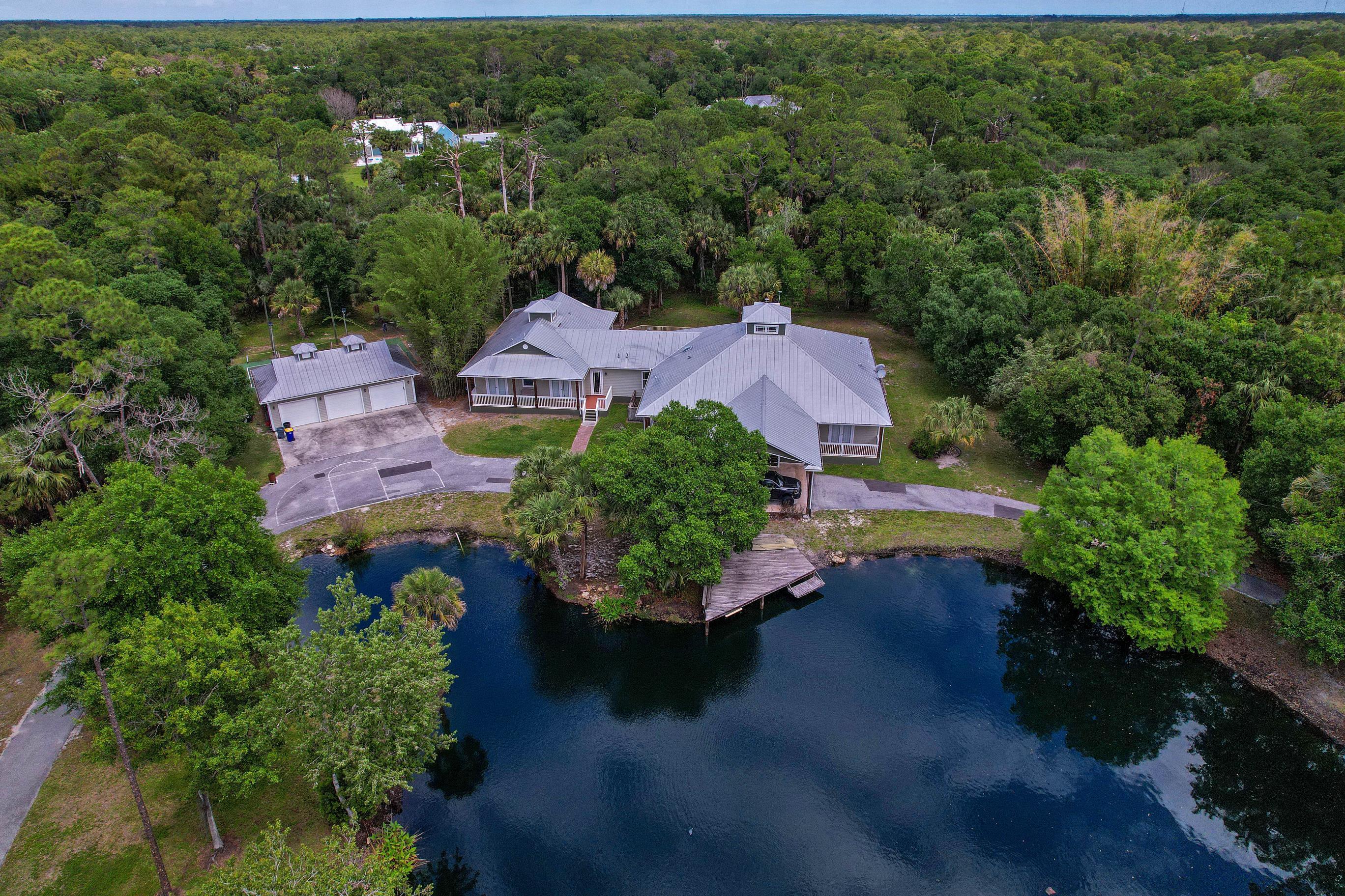 Welcome to this expansive estate set on 5 acres offering an exceptional opportunity to create your dream home in one of the area's most sought after locations. With five bedrooms, five bathrooms, and over seven thousand total sq.ft, the property combines generous scale, timeless design, & endless potential. Classic architectural elements include a fireplace, numerous French doors, cupolas, spacious rooms, private office & versatile flex room. The home offers a well-designed floor plan ready for your personal vision as well as the possibility for immediate enjoyment. Endless outdoor lifestyle options with a scenic spring-fed lake, private pickleball court, swimming pool & sprawling green spaces. A three car garage plus large pole barn to house your motor home, boat and other vehicles.