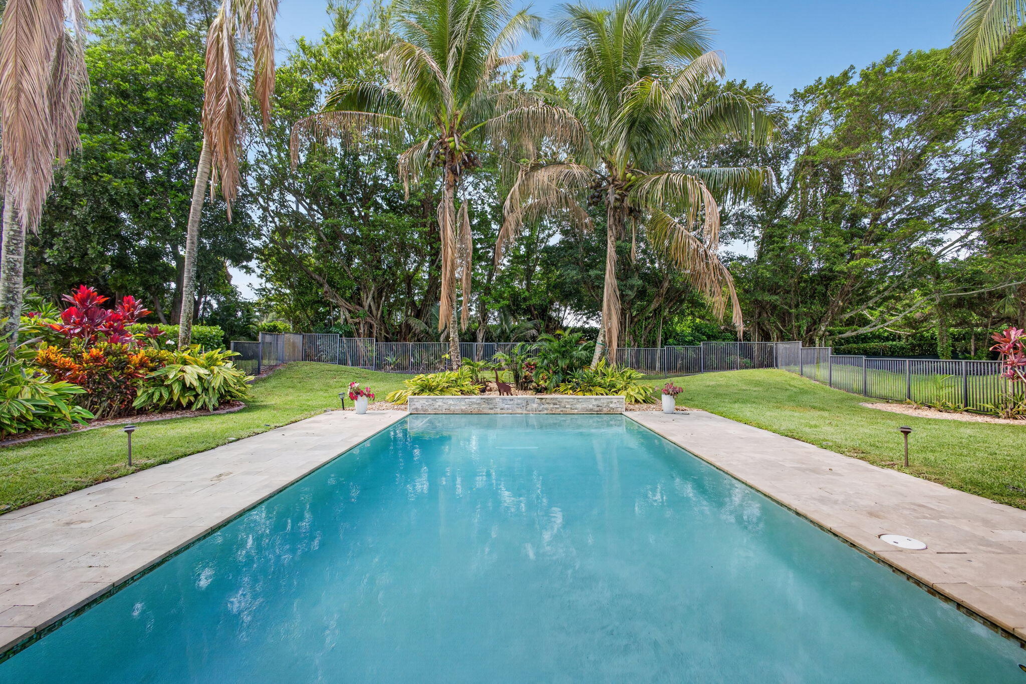 Located within the prestigious Eastpointe Country Club with 24-hour manned security, this home truly has it all. Nestled on an estate-like property with a private, oasis-inspired setting, this meticulously maintained home combines luxury, comfort, and modern upgrades. Featuring 5+ bedrooms, 3.5 bathrooms, and a 2-car garage, the flexible floor plan includes two primary suites—one on the first floor and one on the second—perfect for multi-generational living, guests, or added convenience.  Residents enjoy the exceptional lifestyle amenities of Eastpointe, including a brand-new clubhouse, resort-style pool, restaurant, fitness center, and an active country club community.   Extensively updated throughout, this home showcases a beautifully renovated kitchen with a waterfall countertop, matching backsplash, stainless steel appliances, built-in beverage/wine cooler, and modern finishes. Elegant 24" x 48" European porcelain tile flooring spans the first floor, while rich hardwood flooring enhances the stairs and second level.  The spacious first-floor primary suite features a custom walk-in closet and a completely renovated spa-inspired bathroom. Recent upgrades include a renovated laundry room, two new Trane A/C units, a home EV charger, whole-home water filtration system, reverse osmosis kitchen filtration, and a Ring security system with cameras and floodlights.  Enjoy Florida outdoor living with a heated pool, travertine patio, large awning, and fully fenced backyard. Additional features include impact windows and garage doors, Bahama shutters, electric fireplace, Samsung washer and dryer, and LG stainless steel kitchen appliances.
