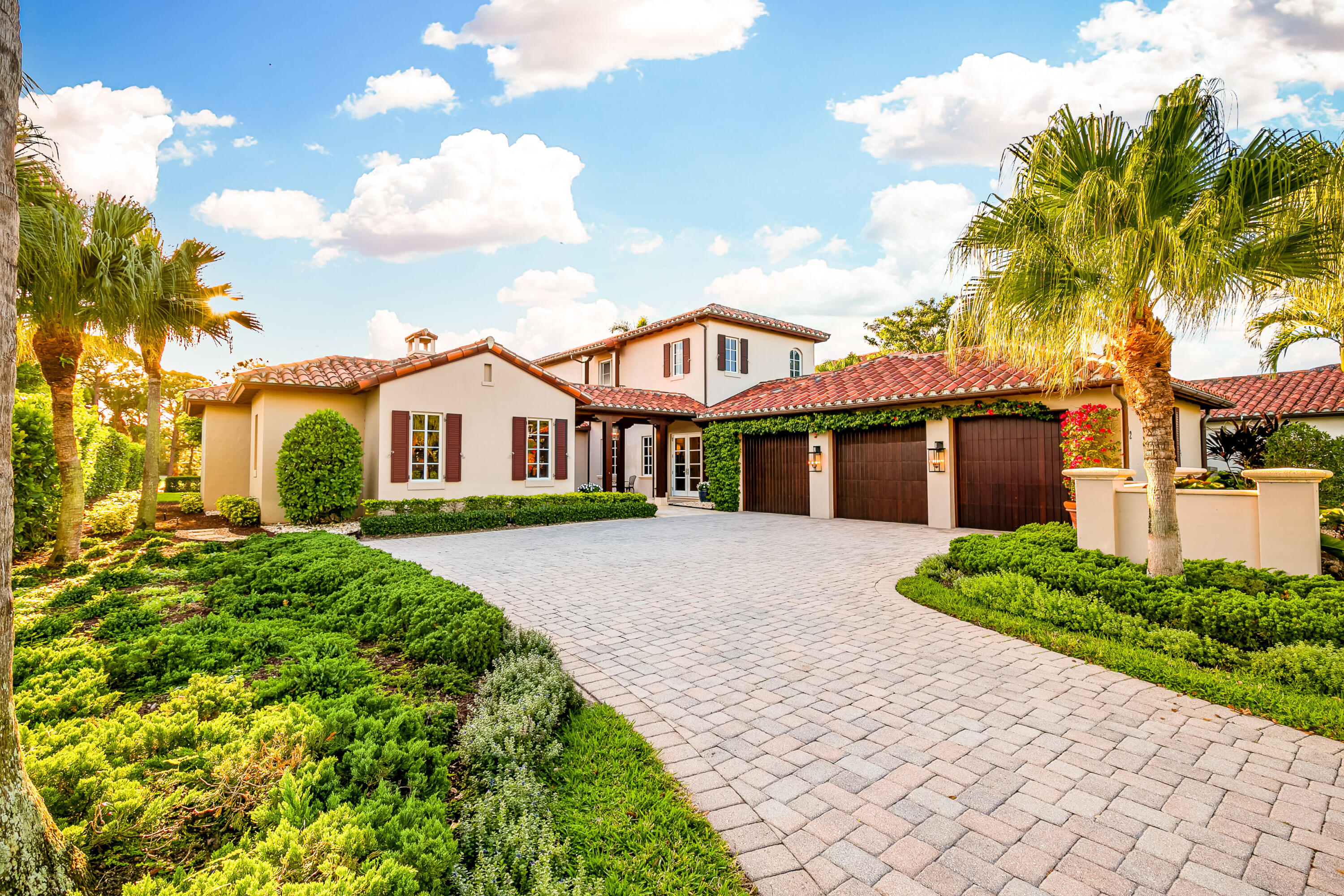 Welcome to this remarkable 4-bedroom, 5.5-bathroom custom home, a true gem nestled within the exclusive Eagle Tree at Trump National Jupiter, offering unparalleled luxury and distinctive features rarely found elsewhere. Overlooking the 8th hole of the renowned Jack Nicklaus golf course, this meticulously maintained residence boasts an array of exceptional upgrades designed for the ultimate lifestyle.

Upon entry, you'll discover a homeowner's dream—a FULL 3-car, air-conditioned garage featuring multiple layered epoxy floors, a haven for sports car enthusiasts. Step outside to your extended lanai, complete with an electric awning and ceiling fans, the perfect spot to savor your morning coffee or bask in the allure of the heated pool and jacuzzi. The heart of this home, the open chef's kitchen, stuns with its marble countertops, a seamless marble breakfast island, and top-tier appliances including Wolf double ovens, a natural gas 6-burner range with true exhaust ventilation, Miele dishwasher, hidden GE refrigerator drawers, and a large SubZero refrigerator. Marvel at the spectacular recessed and under-cabinet lighting enhancing this culinary haven.

Entertainment abounds within the extended family room featuring an updated built-in entertainment center with modern accents, motorized screens, and in-ceiling surround sound speakers, ensuring an optimized audio-visual experience.

The master bedroom, extended for added comfort, includes his and hers walk-in closets, a separate tub, a large glass-enclosed shower, and a unique "hurricane safe room" for added peace of mind during extreme weather events.

This home embraces privacy and elegance with a downstairs guest bedroom and ensuite bathroom accessed through the courtyard, while the lush backyard, maintained by the association, boasts breathtaking LED landscape lights and an expanded green space, offering a tranquil oasis.

Beyond the luxurious features, this residence benefits from the exclusive services provided by Eagle Tree Jupiter, including a personal concierge who can manage every aspect of the home including vacant home checks while you are away, pool care, landscaping services, and private garbage pickup, ensuring a luxury residential experience.

Notably, the home is equipped with advanced hurricane protection, impact windows and doors, a whole-house natural gas generator monitored by ON-STAR, ensuring safety and convenience.

Additionally, upgrades to the HVAC system, exterior improvements, a Navien gas powered tankless water heater, and meticulous maintenance ensure a home that's as functional as it is elegant.

In summary, this home offers a true luxury experience in Jupiter without mandatory membership requirements, showcasing exceptional living spaces and unparalleled comfort. With the possibility of expansion and a wealth of unique features, this property stands as a testament to meticulous design and unparalleled comfort. Don't miss the opportunity to own this exceptional home with a fusion of elegance, technology, and safety at its core.