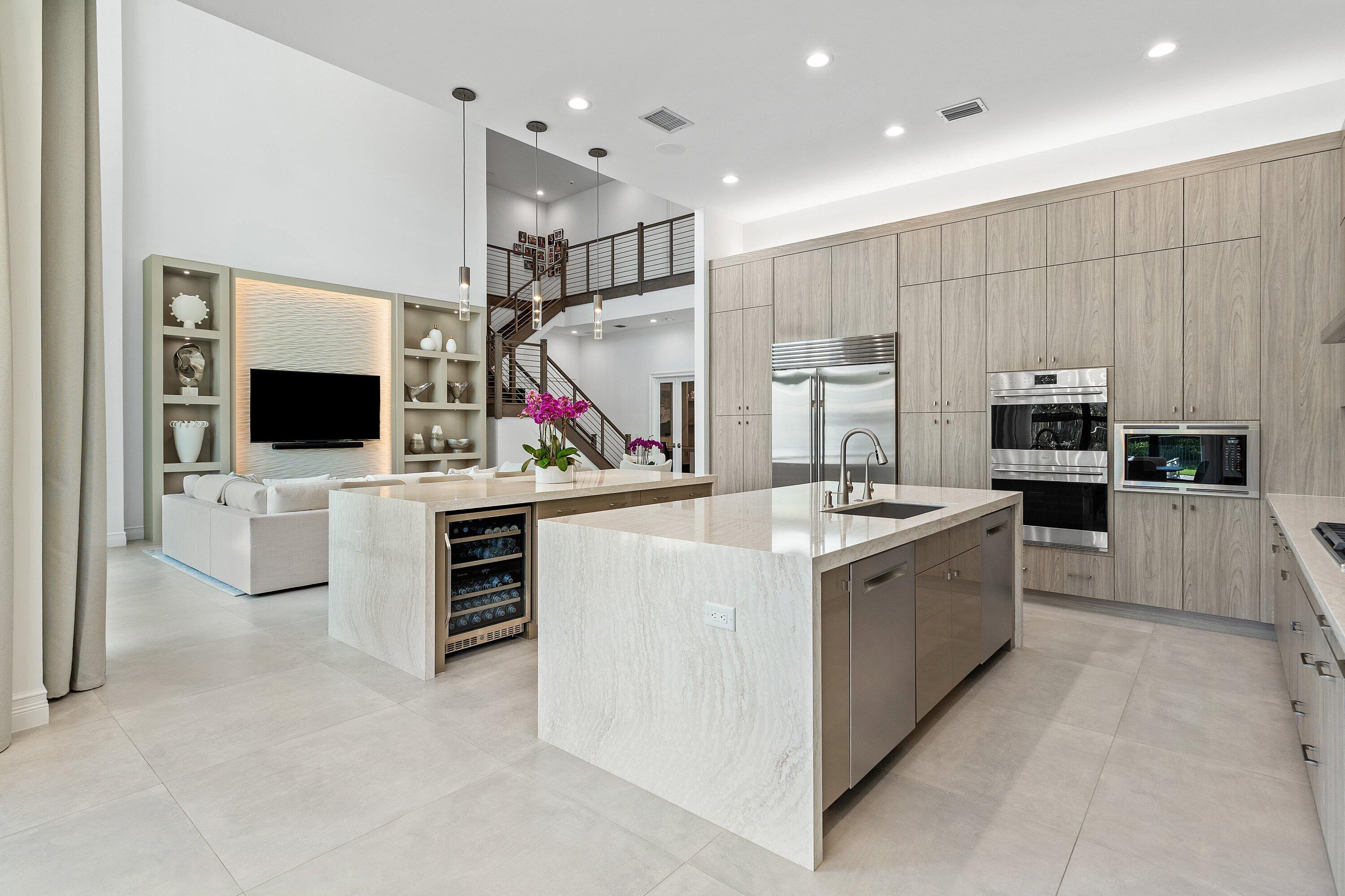 Professionally designed by Brown Interiors! Welcome to 17432 Ponte Chiasso Drive, this exceptional Veneto estate built in 2022, located in prestigious Boca Bridges, feels brand new and sits on a private, 1/3 acre spacious lot. Spanning just under 6000 SF,  the property features 5 bedrooms and 7 bathrooms. The main level includes a Luxurious Primary Suite, Custom Office, Elegant Living and Dining Room, separate Breakfast Area, Sauna/Flex Room, and Guest Suite with ensuite bathroom. Upstairs features 3 VIP suites with en suites, Movie Room, and a Spacious Loft. Situated with the preferred North/South exposure, offering great natural light all year long. The chef's kitchen boasts Two huge islands, Two dishwashers, a Wine Refrigerator, Double Oven, Gas Range and Sub-Zero & Wolf appliances!   The property's highlight is its extraordinary, expanded outdoor "resort" pool and spa oasis, an entertainer's dream that transforms outdoor living into a luxurious experience. This remarkable space was thoughtfully designed and features a summer kitchen, entertain all year long with al fresco dining and social gatherings. The interior embodies a sophisticated soothing designer aesthetic, with large format 36x36 tiles and hardwood floors. This floor-plan rarely becomes available in the community!   Boca Bridges is an upscale, gated community that promises an unparalleled living experience. Boca Bridges has a magnificent 27,000 square-foot clubhouse, providing residents with access to a resort-style pool and a full-service gourmet restaurant and bar.  For those seeking an active lifestyle, there is a state-of-the-art fitness center, offering a range of exercise classes. The community has tennis courts, pickle-ball courts, both indoor and outdoor basketball facilities, and a card room.  Families can enjoy a kid's splash park, an outdoor pavilion for parties, a game room, and many kids' activities throughout the year.