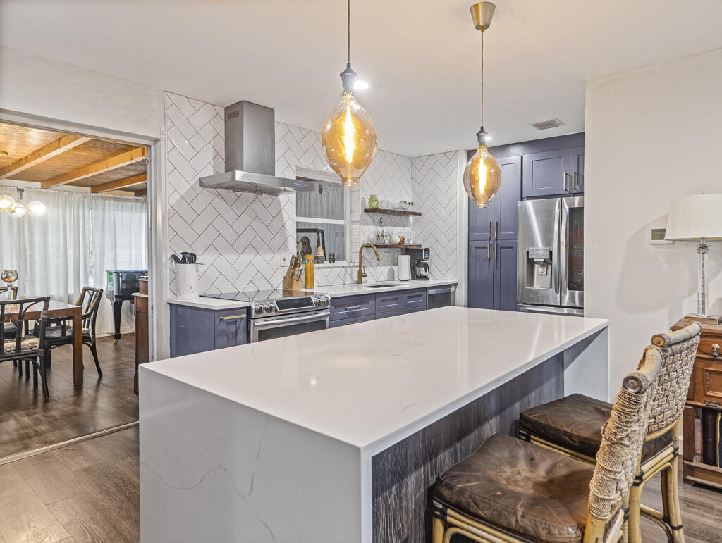 Stylish indoor living meets lush outdoor spaces in a quiet neighborhood in Lake Park. This upgraded home features a quartz waterfall-edge island, stainless steel appliances, and modern finishes throughout, including new interior doors and hardware, fresh paint, and a recently installed central A/C (2024) replacing wall units. The insulated Florida Room with wood ceiling adds valuable living space, while additional updates include new sod and native landscaping, expanded sprinkler system, new hot water tank (2025), new dryer (2025), and Wi-Fi front door lock (2026). Sold 'As Is'. PROPERTY IS BEING SOLD SUBJECT TO AN EXISTING SEASONAL LEASE FROM OCTOBER 1 - MAY 31. BUYER WILL ASSUME THE LEASE AT CLOSING.