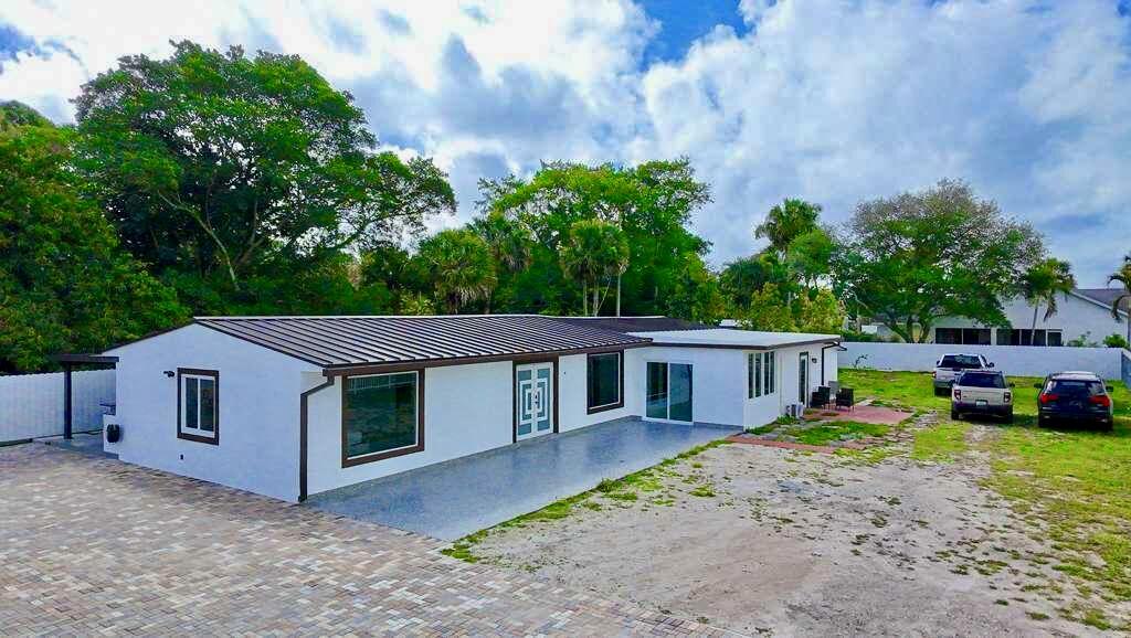 BEAUTIFUL HOME!! 4 bedrooms and 2 bathrooms, this property offers a spacious backyard with lush avocado trees, fully fenced for privacy. Enjoy your mornings on the open porch with a relaxing cup of coffee. The home includes a Brand New Metal Roof (2025) and impact windows and doors for added durability and peace of mind. Ideally located near major highways, beaches, City Place, and more, this property offers both comfort and convenience. Don't miss this incredible opportunity to make this house your Home!