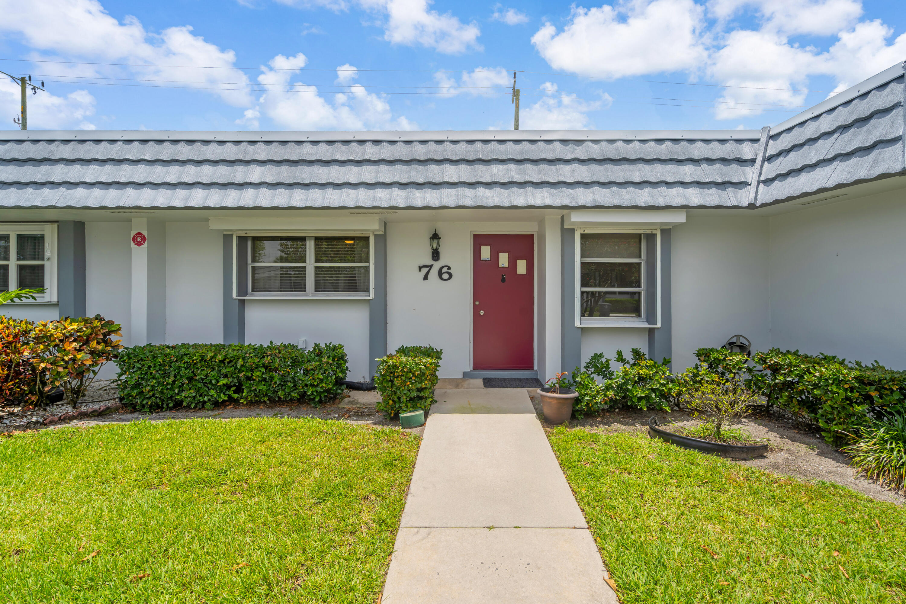 Welcome to this beautifully maintained two-bedroom, two-bathroom villa in the desirable 55+ community of Cresthaven in West Palm Beach. Offering 1,014 square feet of comfortable single-level living, this home features a spacious open floor plan, neutral tile flooring throughout, and impact windows for added peace of mind.  Enjoy tranquil canal views and expansive green space from your backyard, with the clubhouse, pool, and tennis courts just a short walk away. Whether you're looking for a year-round residence or a seasonal retreat, this home offers low-maintenance living with an assigned parking space and HOA dues that include basic cable, water, sewer, and exterior maintenance.
