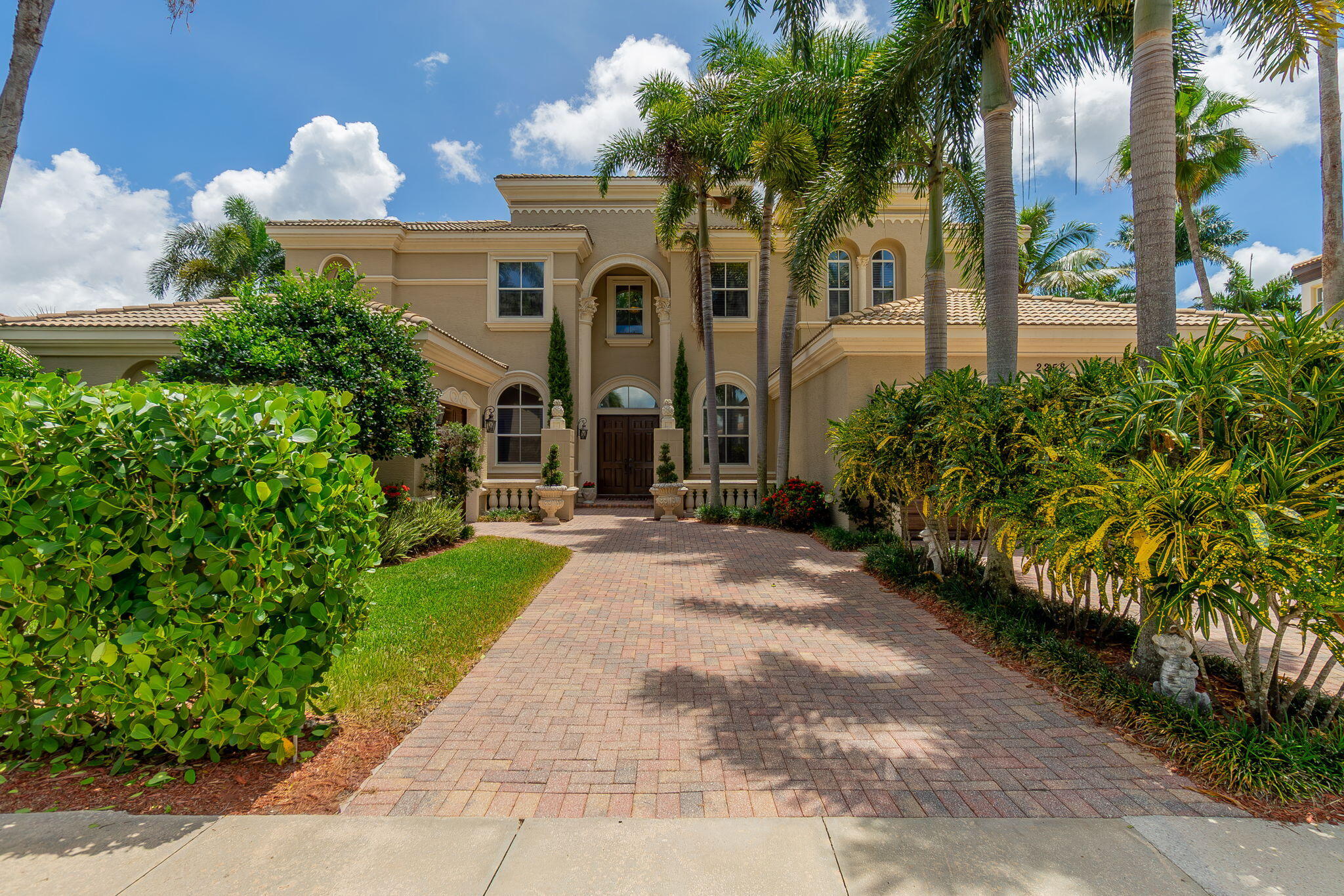 Experience luxury lakefront living in this spectacular Casa Della Scala estate located in the prestigious gated community of Olympia in Wellington. Situated on a premium waterfront lot, this grand Mediterranean-style residence offers over 5,600 square feet of elegant living space with 6 bedrooms, 8.5 bathrooms, a library/office, and a 3-car garage.   From the moment you enter, you are welcomed by a dramatic double staircase, soaring ceilings, French pattern travertine flooring, stunning lake view and an impressive foyer designed for unforgettable first impressions.   The spacious primary suite is a true retreat, complete with a private sitting area, balcony overlooking the lake, and separate his-and-her bathrooms. With 2 bedrooms downstairs and 4 upstairs, the layout offers exceptional flexibility for guests, multigenerational living, or work-from-home needs.   Outside, enjoy breathtaking lake views, lush landscaping, and the privacy and serenity that make this home one of Olympia's standout properties. Residents enjoy access to resort-style amenities including a clubhouse, fitness center, pool, tennis courts, playgrounds, and scenic walking paths.   Located in the heart of Wellington — world-renowned for equestrian living, top-rated schools, shopping, dining, and recreation — this exceptional estate offers the perfect blend of elegance, comfort, and South Florida lifestyle.   Furniture negotiable. Video tour: https://brown-bear-productions.aryeo.com/videos/019e66c4-6340-718c-9c90-5b5e13805583