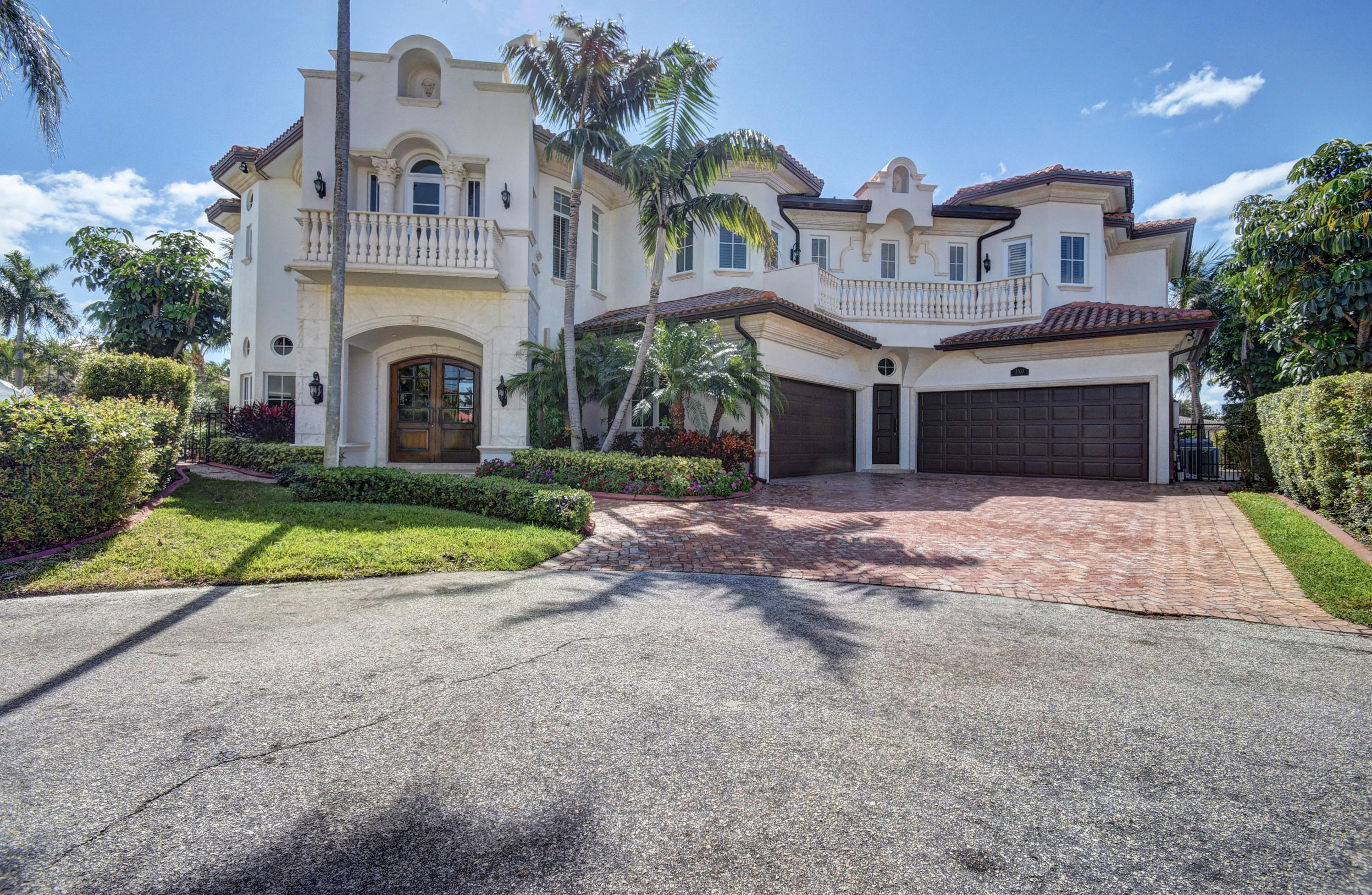 Stunning point lot views from this cul-de-sac 6 bedroom, 6.5 bath estate home located on 200 plus ft of extraordinary deep water. Huge master suite with separate his & hers bathrooms, sitting area and expansive covered balcony to enjoy the breeze and watch boats go by on the intracoastal. Huge club room with wet bar, 4 car garage,FP living/dining room, gourmet kitchen w/WOLF appliances and solid wood custom cabinetry,designer marble floors thruout lower level,crestron lighting system, temperature control wine cellar, gorgeous wood spiral staircase w/ wrought iron rails, wood floors on the upper level. Entertain on the large covered veranda overlooking the pool & waterway w/ summer kitchen & bar. Full house generator and impact glass. This has absolutely everything! Spectaclular wide canal