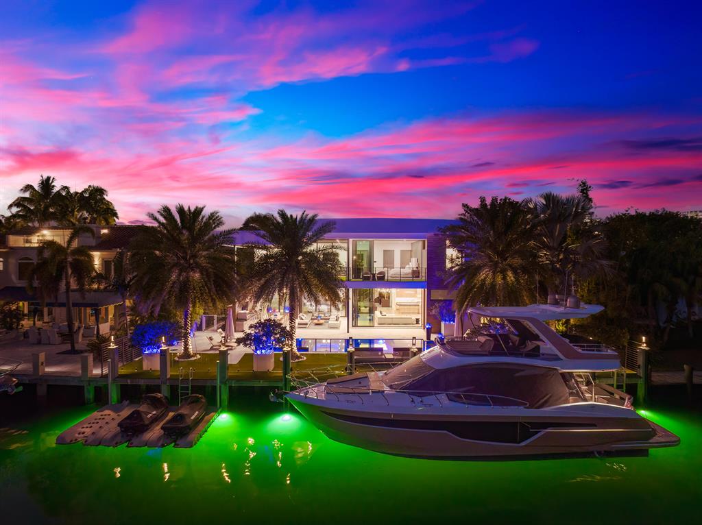 Fort Lauderdale, Florida, a weekend paradise, a delightful blend of events and attractions to suit every taste. Bask in the sun during Spring Break celebrations or attend the Tortuga Music Festival, Las Olas Art Fair, and an array of food and wine festivals. The thrilling Fort Lauderdale Air Show and the prestigious Fort Lauderdale International Boat Show are also among the city's highlights. With year-round sunshine, dynamic nightlife, and numerous activities within walking distance, Fort Lauderdale promises an unforgettable experience for all. Nestled within the esteemed Seven Isles community. Discover unmatched luxury and sophistication at 2542 Aqua Vista Blvd, an exquisite waterfront property. This architectural masterpiece features a modern organic design and impeccable finishes, creating an extraordinary living experience. Natural light floods the expansive 5-bedroom, 7-bathroom residence, showcasing thoughtfully designed interiors. The gourmet kitchen boasts bespoke oak cabinets, state-of-the-art Wolf and Viking appliances, and a spacious island with a breakfast bar overhang, all while offering stunning waterfront views. An artistic staircase and living moss wall connect to the second level, where each room features a private balcony, providing awe-inspiring views of the waterways. The opulent master suite includes a wrap-around terrace, a spa-inspired bath with a sauna, a rainfall shower, a soaking tub, dual floating vanities, and water closets. A glass 3-car display garage houses a golf simulator adjacent to the home office and club room, perfect for entertaining. The meticulously designed backyard offers covered terraces, a summer kitchen, a bar with a pizza oven, and a heated saltwater pool and jacuzzi, all surrounded by lush tropical landscaping. This extraordinary property also features a full gym, a custom 300-bottle wine vault, a formal dining room, a built-in antique brass entertaining bar, an elevator, a movie room/flex space, a Venetian plaster staircase, Control4 Automation smart home technology, framed art TVs, two laundry rooms, and ample storage. Experience waterfront living at its finest, with direct inlet access and a newly built dock that accommodates up to an 80-foot vessel. 2542 Aqua Vista Blvd represents the pinnacle of luxury living, offering an unparalleled combination of location, design, and functionality. This once-in-a-lifetime opportunity awaits in one of South Florida's most coveted neighborhoods.