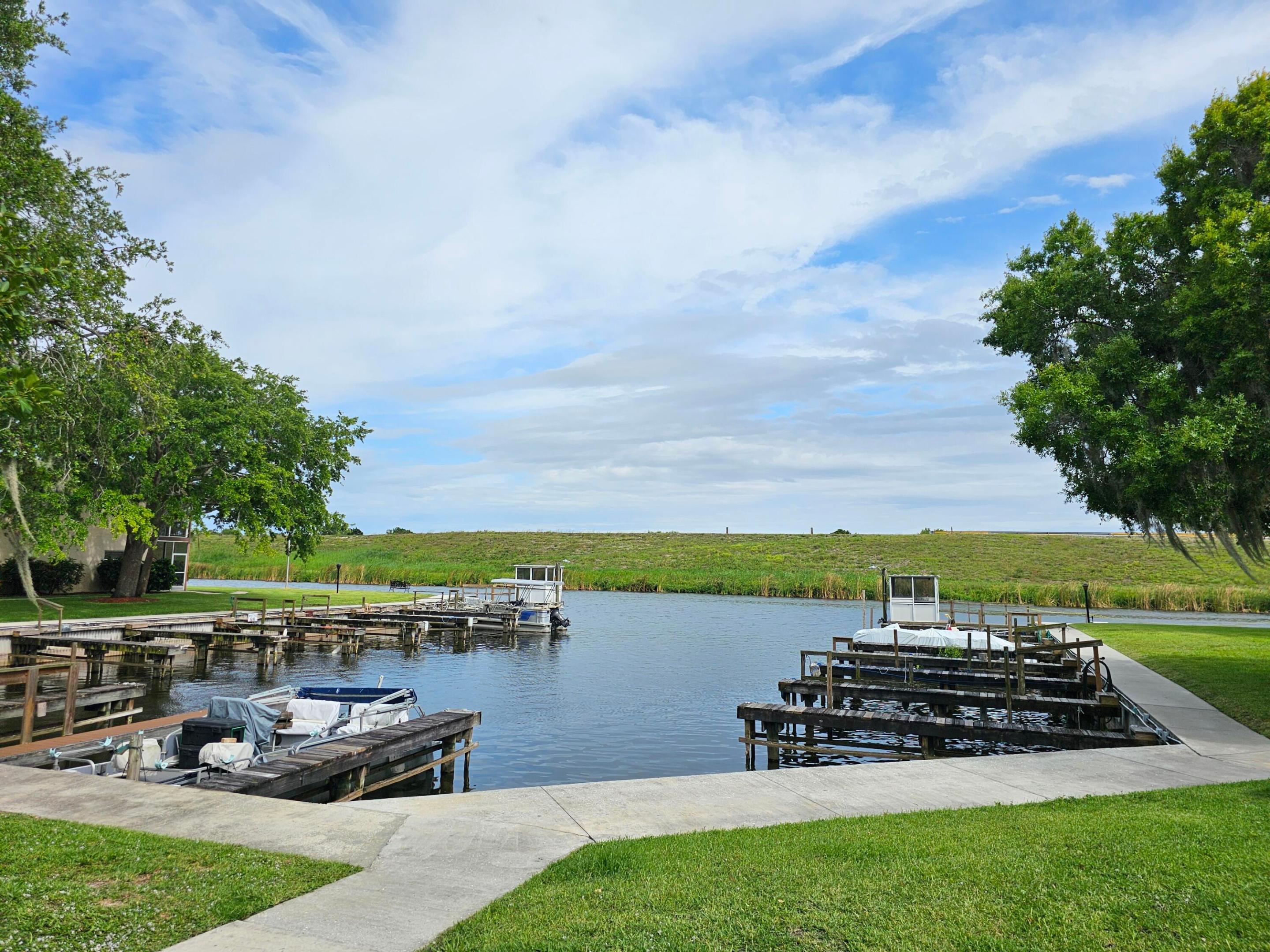 Fishermen and boater's paradise! 2/1 unit in Taylor Creek Condominiums, with great owner benefits including pool, marina, private boat ramp & laundry facility. This desirable condo community is located directly next to the navigation boat locks leading into Lake Okeechobee.  All appliances included, new laminate flooring, screened lanai overlooking the community's private marina with convenient boat slips. HOA fee includes landscape maintenance and all amenities.