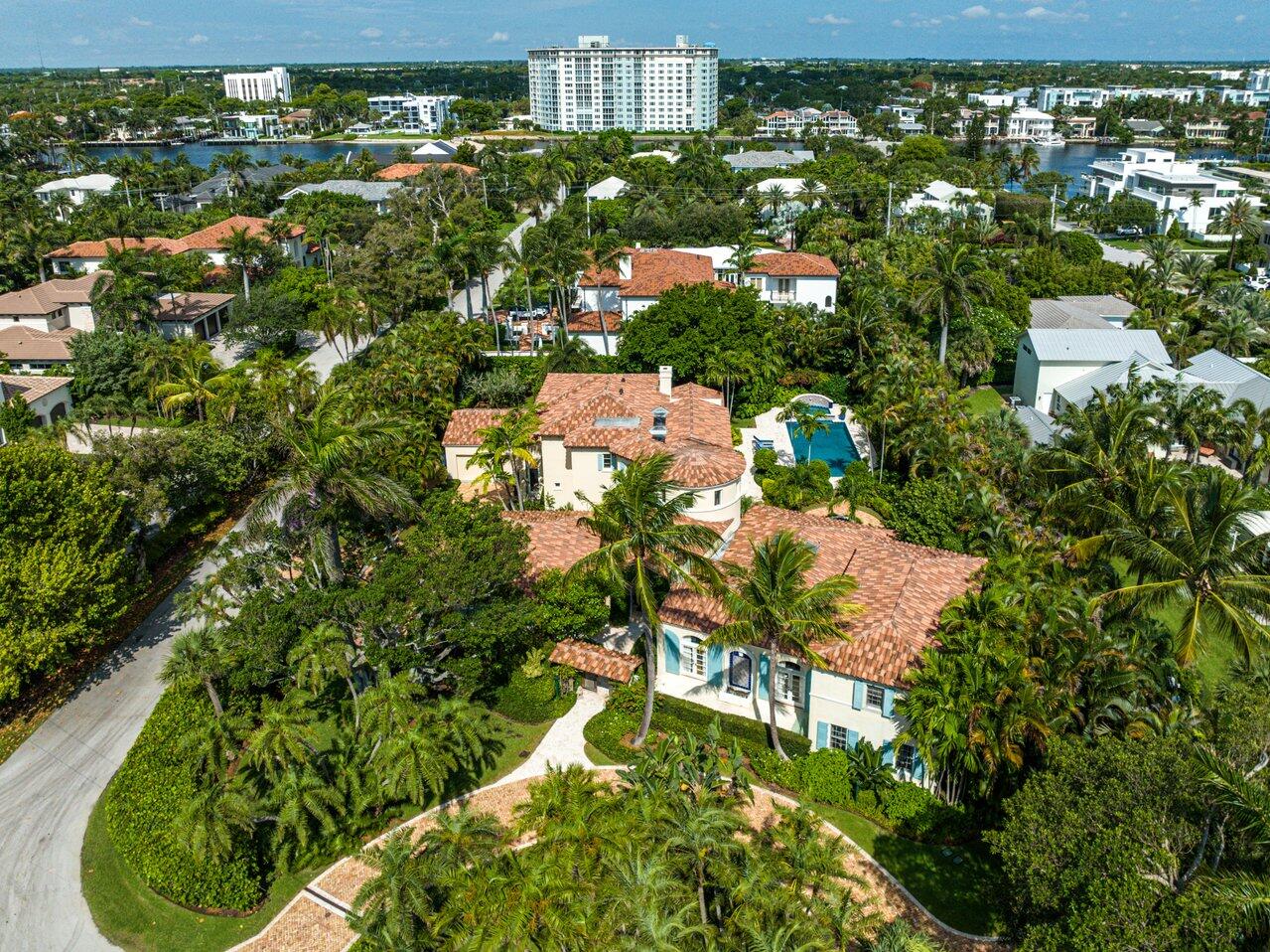 Rarely available, double lot in the Seagate beach area. This captivating corner lot covers over a half acre. Situated less then a mile from Atlantic Ave. Architect Mark Marsh eloquently blended the classic Florida aesthetic with refreshing modern updates. 
Features include three Bayan trees nicely complementing the tropical landscaping.  A court yard, grand entry way. The kitchen has a teak island and wet bar. Elevator to the primary bedroom suite. first floor VIP Suite, two upstairs guest rooms in the north wing. two Bedroom guest house with laundry room.  Sprawling outdoor living area, outdoor kitchen, outdoor fire place, Large pool, grand Spa and garden fountain. A large addition was added in 2009.