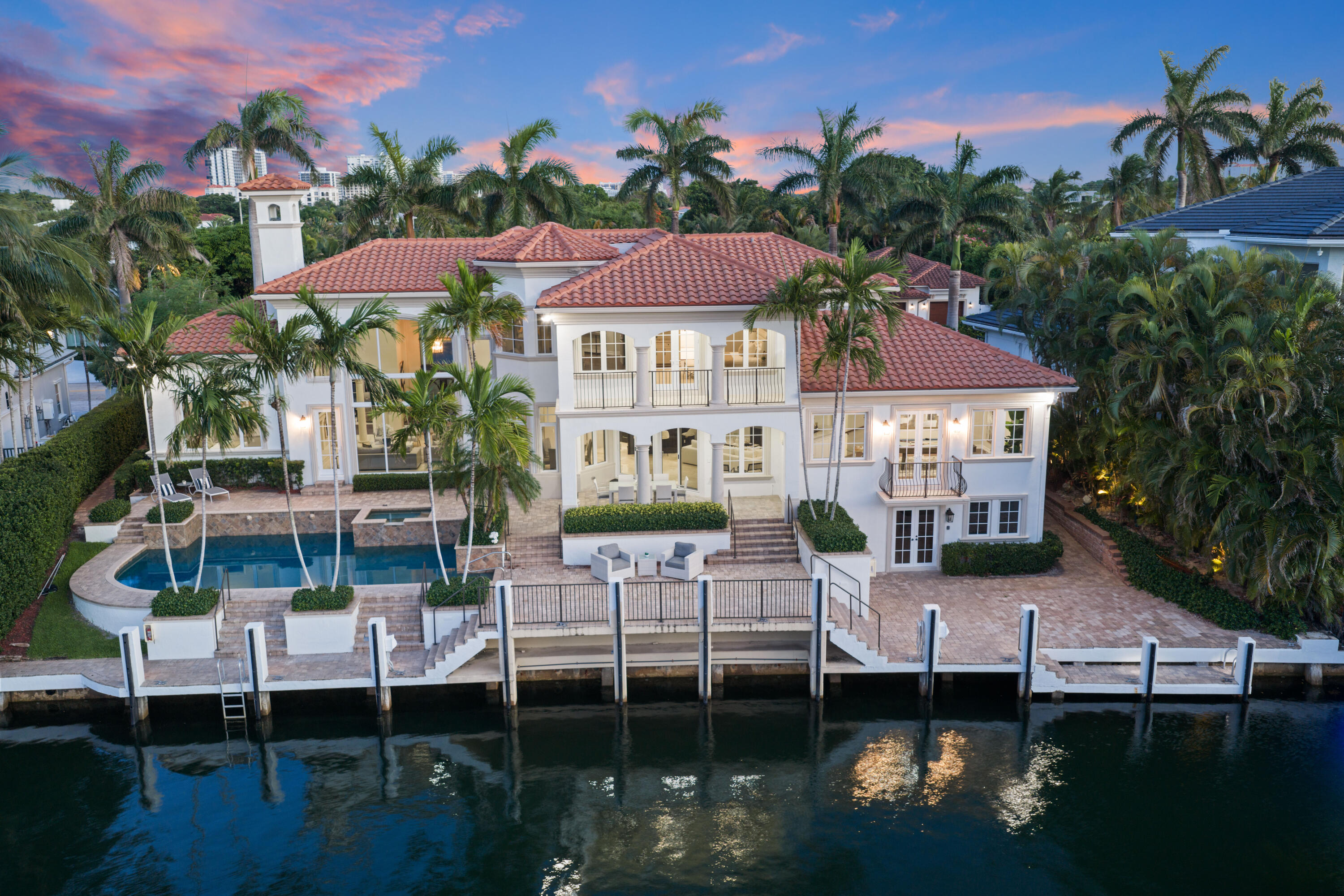 Completely renovated in 2026, this magnificent 6-bedroom, 6 bath home boasts over 5,200sqft and is a true boater's paradise. Perfectly positioned on a seldom-available premium lot in the highly coveted Sun & Surf community, this extraordinary estate, designed by renowned architect Randall E. Stofft, offers 122 feet of deep-water frontage with direct Intracoastal access and no fixed bridges, placing the Boca Inlet and Atlantic Ocean just minutes away.  The stunning residence showcases timeless architecture, exceptional craftsmanship, and breathtaking water views throughout. Upon entry, a dramatic great room with soaring double-height coffered ceilings, an elegant fireplace, and a sweeping staircase immediately draws your eye to the sparkling waterfront beyond.  Designed for both grand-scale entertaining and everyday luxury, the great room flows seamlessly into the formal dining room and stunning chef's kitchen, featuring custom wood cabinetry, an oversized island, quartzite countertops, SubZero refrigerator, dual sinks, two Miele dishwashers, a Wolf gas cooktop with pot filler, double Wolf wall ovens, and a spacious breakfast area. The kitchen opens to the oversized family and club rooms, all enjoying spectacular water views.   The thoughtfully designed first floor includes a bedroom wing with three airy and bright bedrooms boasting oversized and built-out closets, as well as three fully renovated bathrooms.  On the other side of the home, there is an additional guest suite with an ensuite bath and walk-in closet, as well as a laundry room with bountiful storage.      Upstairs, the expansive primary suite serves as a true private retreat, complete with elevator access, dual oversized walk-in closets (including one with an additional washer/dryer), a breakfast bar, sitting area, and a lavishly renovated spa-inspired bath. French doors open to a private waterfront balcony, while panoramic water views can be enjoyed from nearly every vantage point. An additional upstairs bedroom features an ensuite bath and spacious closet.    Luxury finishes abound, including newly installed hardwood flooring in all of the bedrooms, marble flooring throughout the main living areas, custom-built closet systems, all-new HVAC systems and appliances, impact windows and doors throughout, a three car garage, and a whole-house generator.   Ideally situated directly across from Red Reef Park and its scenic Par-3 golf course, and just blocks from the beach, The Boca Raton and downtown Boca and Delray, this remarkable estate offers the ultimate combination of boating, coastal living, and refined luxury.