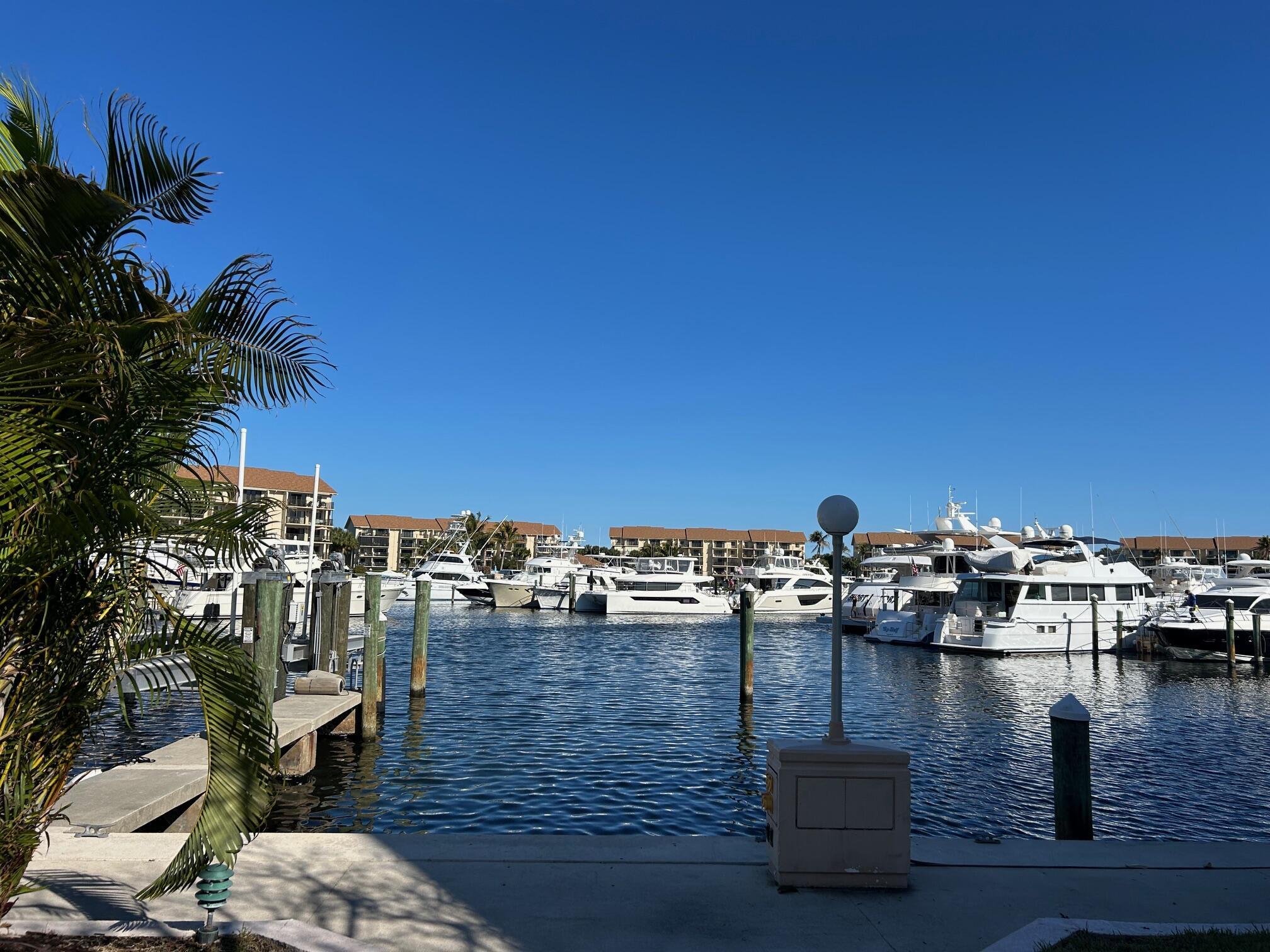 1st floor condo located on the Marina! Walk out to a open patio with plenty of room for family or friends to stretch out, sipping coffee or a glass of wine and enjoy the outdoors and views of the boats sailing in and out of the marina.  ONE OF ONLY 2 BUILDINGS IN THE MARINA THAT DOESNT HAVE A 1 YEAR WAIT TO LEASE!! This 2 bedroom, 2 bath condo has a bonus room all set up with a murphy bed (sleeps 2) while it also can be used as a office or den.  Porcelain wood tile flooring throughout, fully renovated kitchen with new countertops, cabinetry and stainless steel appliances.  Crown molding throughout, ship lap walls in living and dining rooms, solid core doors, matching custom wood shutters in every room, and the list goes on! Every December the Christmas boat parade is a family event that  the residents of the Bluffs Marina can enjoy without having to leave the premises.  Children and people of all ages enjoy this yearly Holiday Traditon   Located in Jupiter's ever popular Bluffs Marina where residents enjoy four pools, a private beach, tennis and bocce ball.  Selling unfurnished but furniture is negotiable