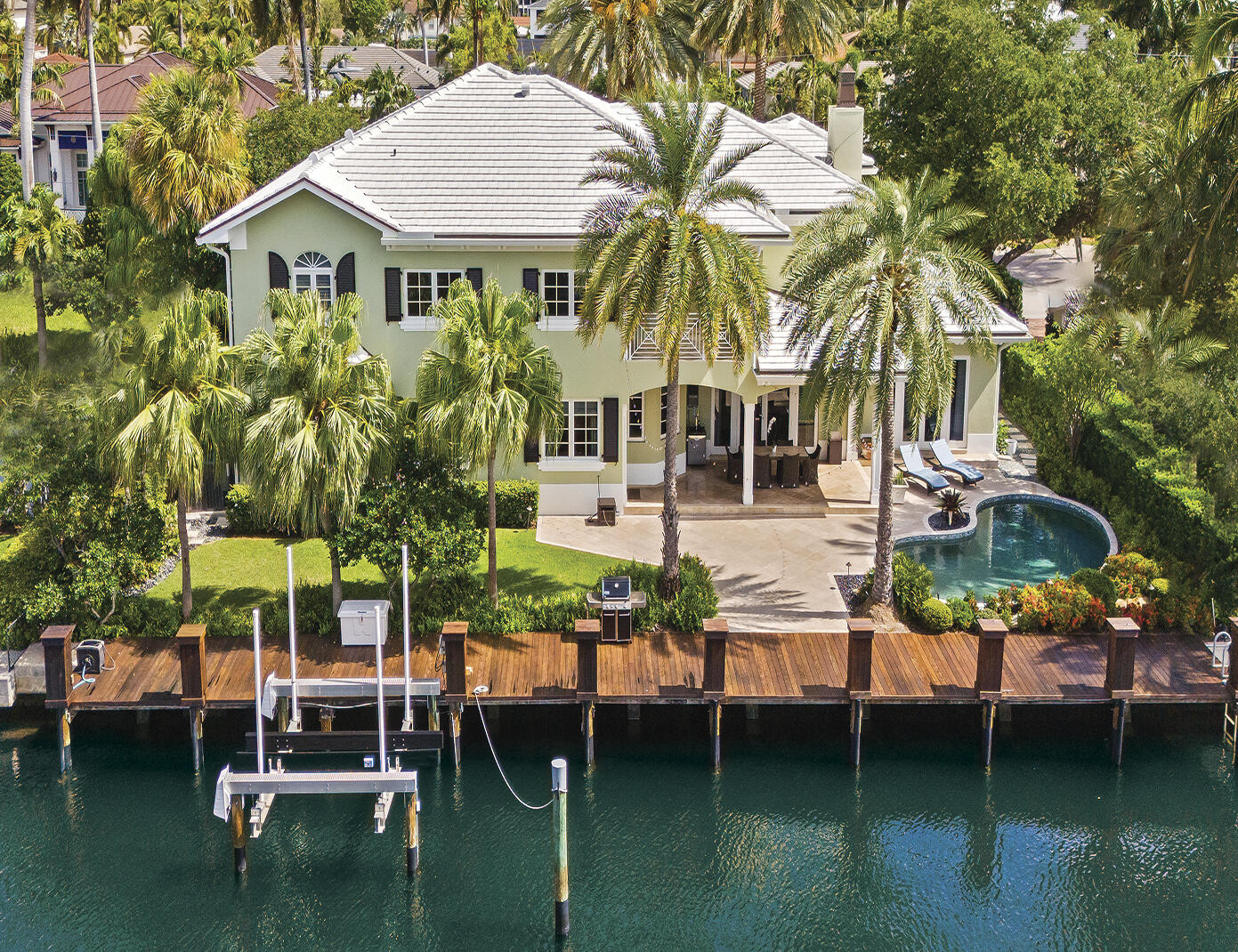 Inspired by British West Indies architecture, this custom built deep water estate offers no fixed bridges, ocean access, 100' of straight-line dockage & a boat lift  Tailored interiors evoke a refined coastal lifestyle with luminous open concept living spaces, soaring 2 story foyer & great rm, seamless indoor-out flow. The chef's kitchen will inspire those who cook with premium appliances, gas range, & abundant storage. Entertain effortlessly with a wet bar & temperature-controlled wine rm. The covered terrace overlooks the heated pool & lush tropical grounds. The primary suite features a sitting area, waterside balcony, dual walk-in closets & spa inspired bath. Additional highlights include a home office, 2nd floor flex rm, integrated sound system & home generator.  Sq ft per architect