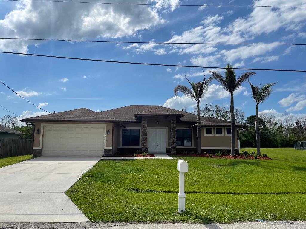 This is a 2019 Custom Built Home. Just freshly painted Interior. 4-bedroom, 3-bath home offering over 2400 SQ FT under air. Exceptional upgrades throughout. This spacious residence features an attractive stone front elevation, impact windows, gutters, lush landscaping, tile flooring throughout the entire home, & a desirable open layout perfect for both everyday living & entertaining.  The upgraded kitchen offers wood cabinetry, stainless steel appliances, & ample storage & counter space. Oversized primary suite features dual sinks & a luxurious dual shower in the master bath.  Enjoy added privacy with neighboring homes positioned farther apart, along with a fully fenced backyard perfect for relaxing or entertaining. Other highlights include new water heater, & modern finishes through out.