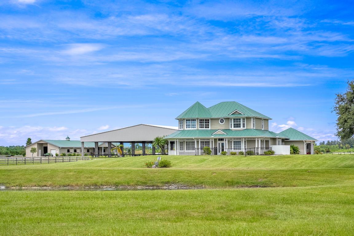 Turnkey Equestrian Estate with FULLY FURNISHED Home, ideally located just 3 miles from the prestigious Apogee Golf Club. This thoughtfully designed and highly functional equestrian facility features a 15-stall center aisle barn with A/C tack and feed rooms, half bath, washer/dryer, grooming areas, wash racks, spray foam insulation, and fans for optimal horse comfort.  Ride year-round in the impressive 120' x 230' COVERED ARENA (2021) with Reiten Right footing and mirrors. The property also includes six large paddocks, cross-country fences, and secure perimeter fencing.  The 2,300 sq ft, 4BR/2.5BA plantation-style home offers a wraparound porch, main-level primary suite, stainless steel kitchen, pool, double garage, whole-home generator, metal roof, and newer A/C systems.  Enjoy beautiful sunsets overlooking the stocked pond, along with a fenced yard and pool area. Sale includes John Deere Gator, zero-turn mower, and all farm equipment—making this a true turnkey equestrian paradise.