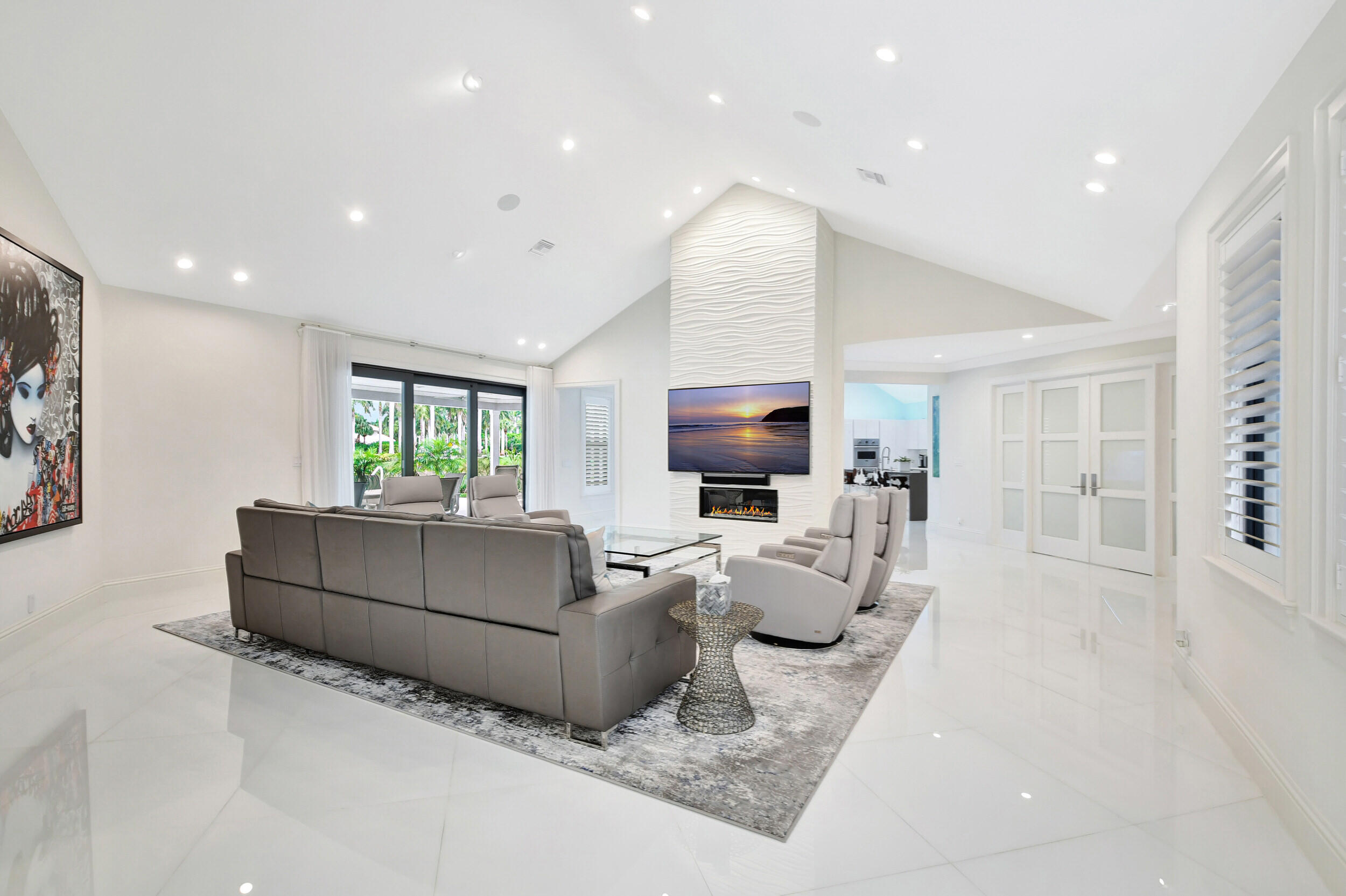 Top-of-the-line finishes adorn this totally renovated 4-bedroom + office home with expansive lake and golf course views. Full-house generator, hurricane impact doors and windows, reverse osmosis water filtration system, large white porcelain tile throughout, SONOS sound system, two NEW water heaters, NEW travertine pavers, and more! Kitchen features a large quartz counter, Thermador professional refrigerator, Viking professional oven, and built-in soda and wine fridges. All bedrooms are ensuite and have spacious custom closets. Master suite includes a large rain shower, 2 sinks, and 2 walk-in closets. Outdoors are open and covered patio areas, a large heated pool with a JACUZZI, lush landscaping, and sprawling lake & golf course views.