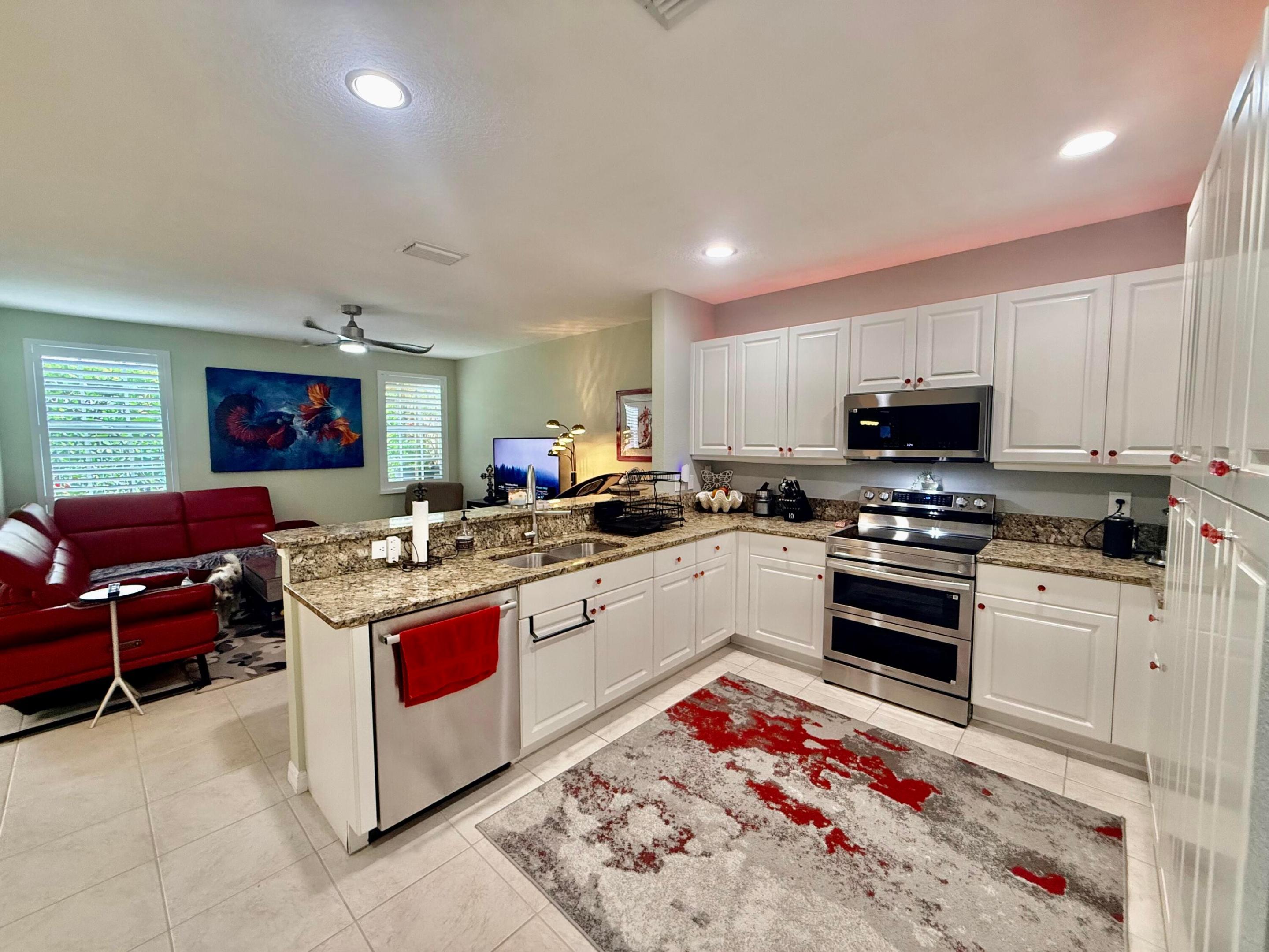 Rare corner townhome located in an end-of-street setting, offering added privacy and charm. Features 3 bedrooms, 2.5 bathrooms, a versatile loft, 2-car garage, private patio, and high ceilings on both floors. Upgraded kitchen with granite countertops, stainless steel appliances, pull-out shelving, and large double pantry storage. Hurricane-impact protection throughout and elegant plantation shutters. Spacious primary suite with two walk-in closets, large shower, and separate roman tub. Flexible loft ideal for an office, home gym, or playroom. Washer & dryer included. Conveniently located just 5 minutes from Atlantic Avenue and 10 minutes from the beach. Near 3 shopping plazas offering a variety of dining, retail, & grocery options, including Publix, Fresh Market, Whole Foods, Trader Joe's