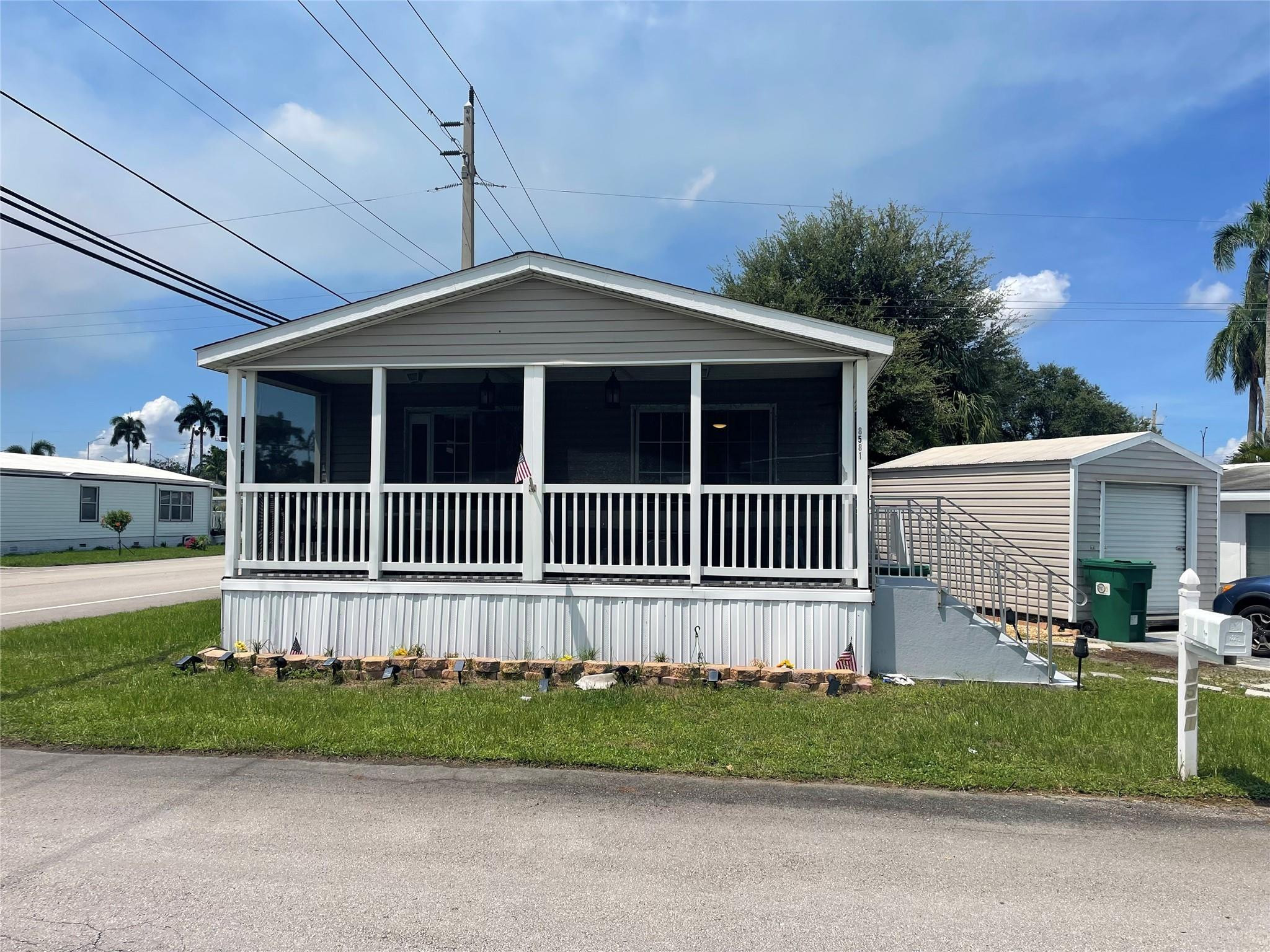 Beautiful 2/2 double wide with screened in patio - -Huge 10x16 shed - -on oversized corner lot in sec 1 with low maintenance fees- -Gorgeous wood laminate floors through out -- -Built in 2008 - -so financing is available - updated cabinetry with multiple lights - Central A/C is approx. 3 years new - -Assoc. states it is HOPA verified - -priced right for quick sale - -truly a must see........******Just reduced***********