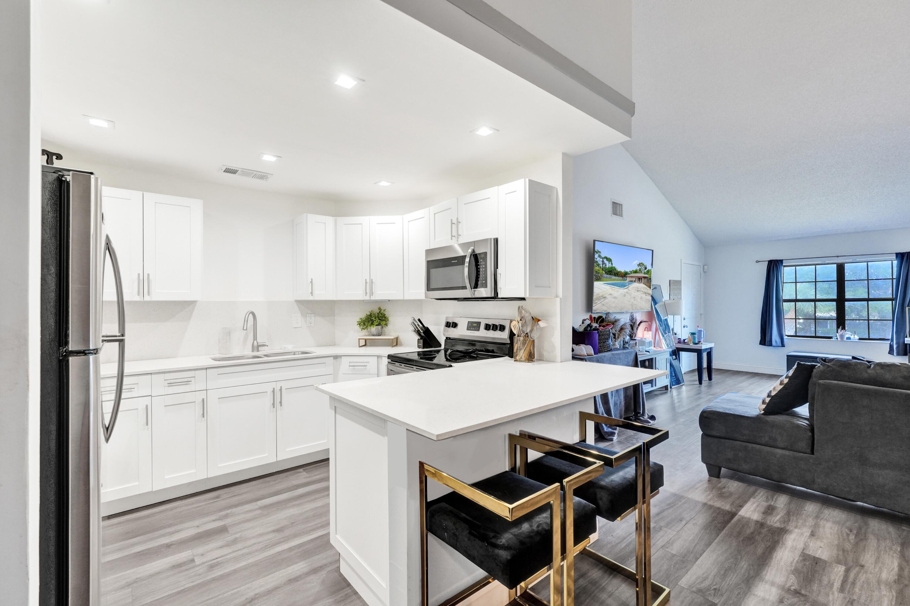 Rare opportunity to own one of only 4 units in Pine Hollow featuring a loft — perfect as a 3rd bedroom, den, or office — and the largest floor plan in the community at 1,320 SF! Soaring vaulted ceilings and an open-concept layout create an airy, spacious feel rarely found at this price point. Fully renovated kitchen with white shaker cabinets, quartz countertops, stainless steel appliances & breakfast bar peninsula. LVP flooring throughout. Generous master suite with walk-in closet & en-suite bath. In-unit washer/dryer. Screened balcony. Community pool. All-ages community. Don't miss this one — units like this don't come up often!