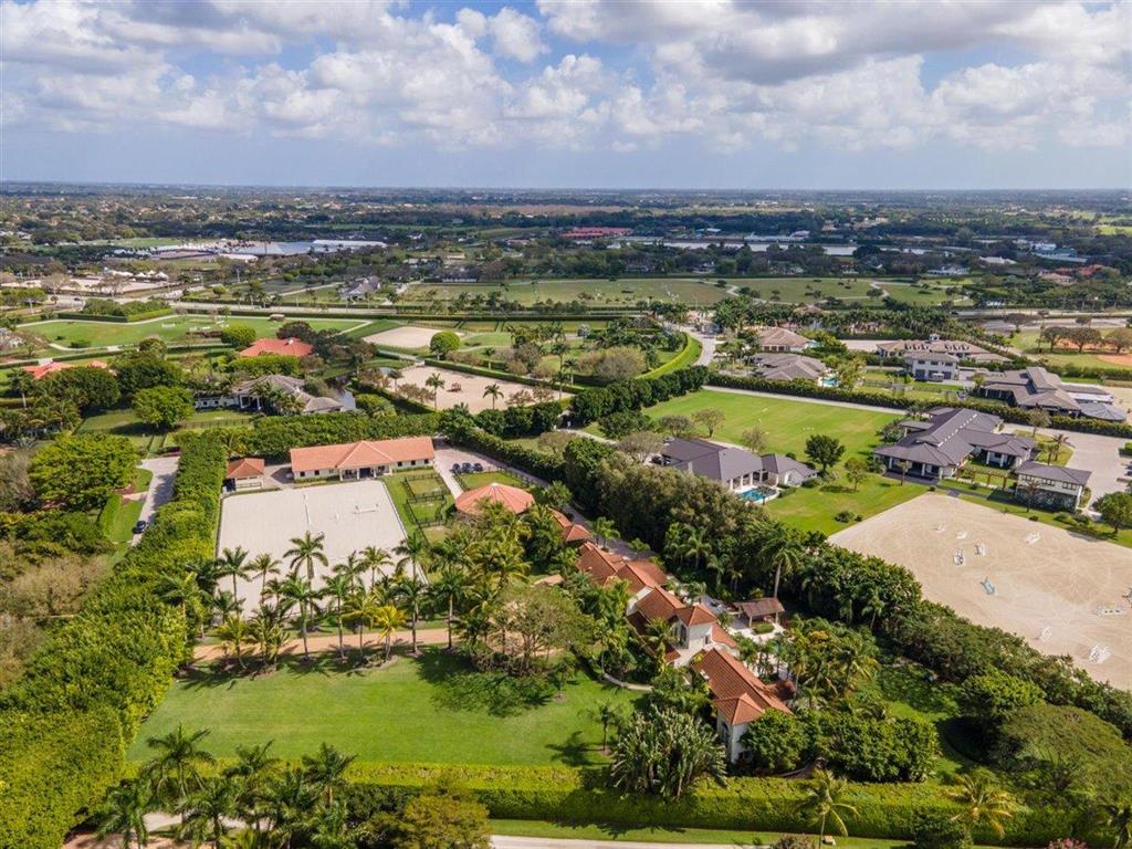Located in the exclusive gated enclave of Mallet Hill, this 4+ acre property offers the the ultimate in privacy that is so hard to duplicate. Surrounded by lush and mature landscaping this 6 bedroom European style home provides stylish amenities for large gatherings both inside or out. Large banquet style dining room with spectacular glass walled wine cellar opens up to the spacious patio and pool area with fire place for those cool evenings. The new 10 stall barn (2019) is the equestrian centerpiece of the property with a  260 X 140 arena that can accommodate both hunters, jumpers and dressage with partial mirror wall. The new (2019) 6 horse MK covered walker is adjacent to the 4 paddocks. Only a short hack to WEF & GDF, Mallet Hill offers the best of both worlds. A Must See Property!