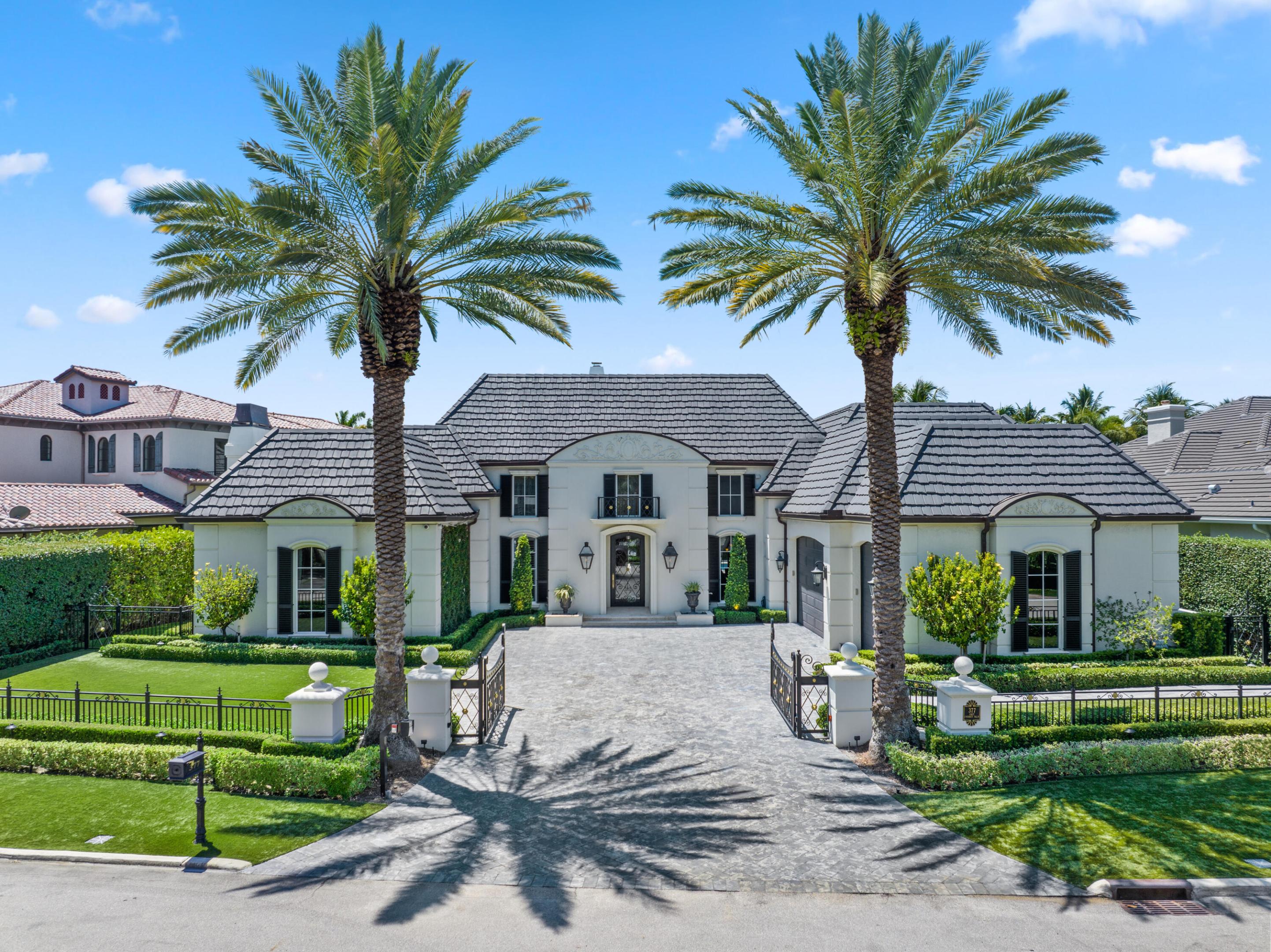An Elegant French chateau-style residence in the prestigious Royal Palm Yacht & Country Club. Situated on 81 feet of deep water Intracoastal canal with no fixed bridges, ideal for yacht dockage. Spanning 6,365 sq ft, this stunning home offers 5 bedrooms, 6 full baths, and 1 half bath with a desirable split-bedroom floor plan. The ground-level primary suite boasts His & Her spa style baths, each with oversized walk-in closets, and French doors opening to the resort-style backyard. Grand foyer entry with marble and hardwood floors throughout. Enjoy a heated saltwater pool, jacuzzi spa, and outdoor grill surrounded by lush landscaping. Additional highlights include a generator, laundry rooms on both levels, and a gated motor court with 3-car garage. This is Waterfront living at its finest!