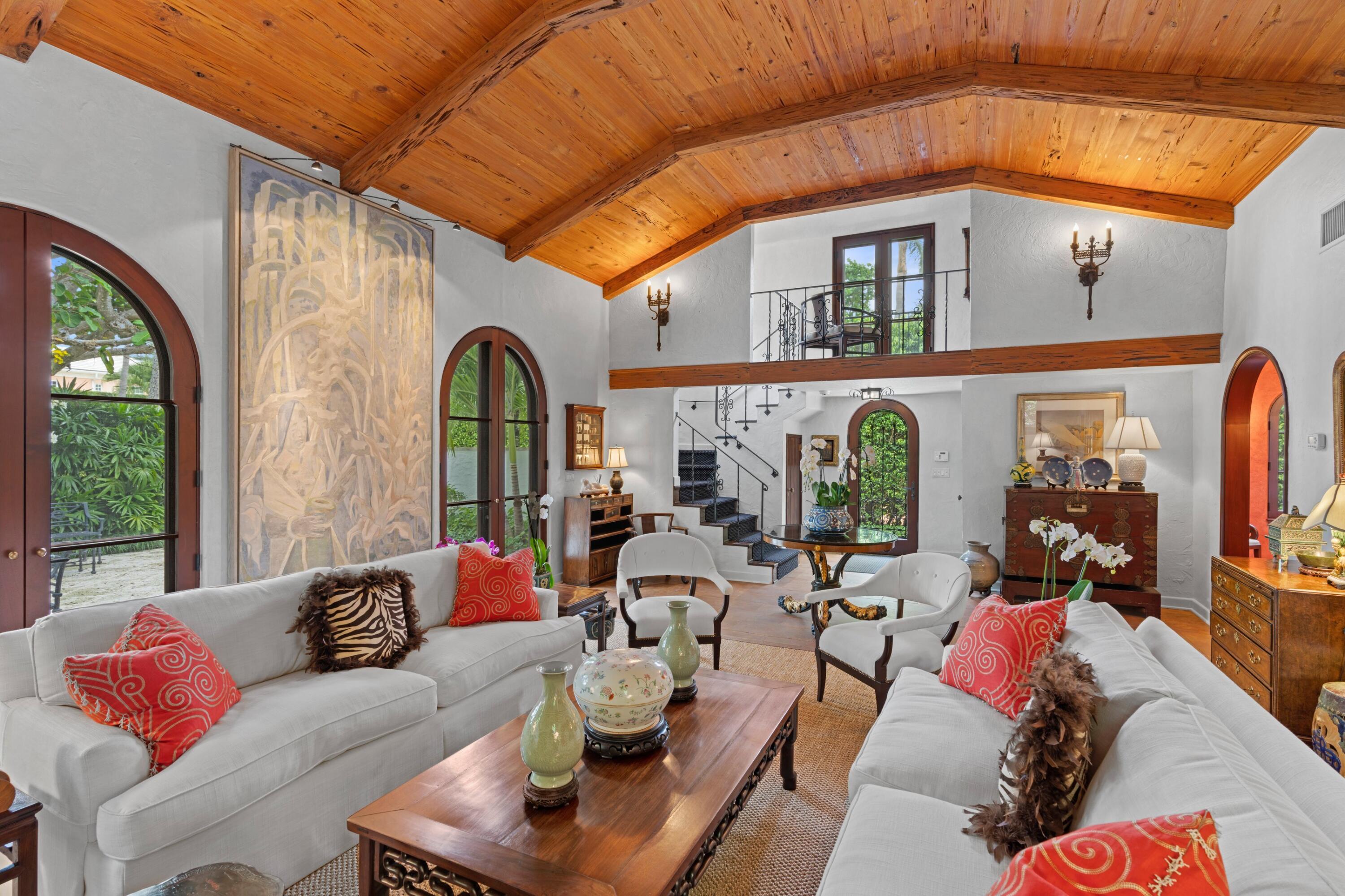 Winner of 2014 Polly Earl Award from the Preservation Foundation of Palm Beach, this rarely available single-family home designed by master architect Maurice Fatio in 1924, sits a half-block from the new Town Docks, on one of Palm Beach's most coveted mid-town streets. The property includes three private courtyards with coquina stone terraces, two fountains and a 10' x 25' heated pool. 
Meticulously and expertly restored, expanded and renovated, the house reflects a seamless combination of original details and modern conveniences, including the highest level of finishes, impact doors and windows.
An arched entry foyer with powder room leads to a stunning living room with vaulted pecky cypress ceiling, original tile floors, and a gas fireplace with mantle fabricated by Herpel. A wonderfully proportioned dining room off the kitchen opens to a casual sitting room with arched windows and doors. A paneled library is thoughtfully designed to convert to a primary bedroom, including ensuite bathroom and adjacent generous closets. A small office is off the library. The 2nd floor includes primary bedroom and guest bedroom, each with ensuite bathrooms and closets. 
A short distance past the south facing, sun-filled pool area lies a large Guest House with 1st floor living room, kitchenette, bedroom and bath plus 2nd floor bedroom, bath and large sun deck each with separate entrances.