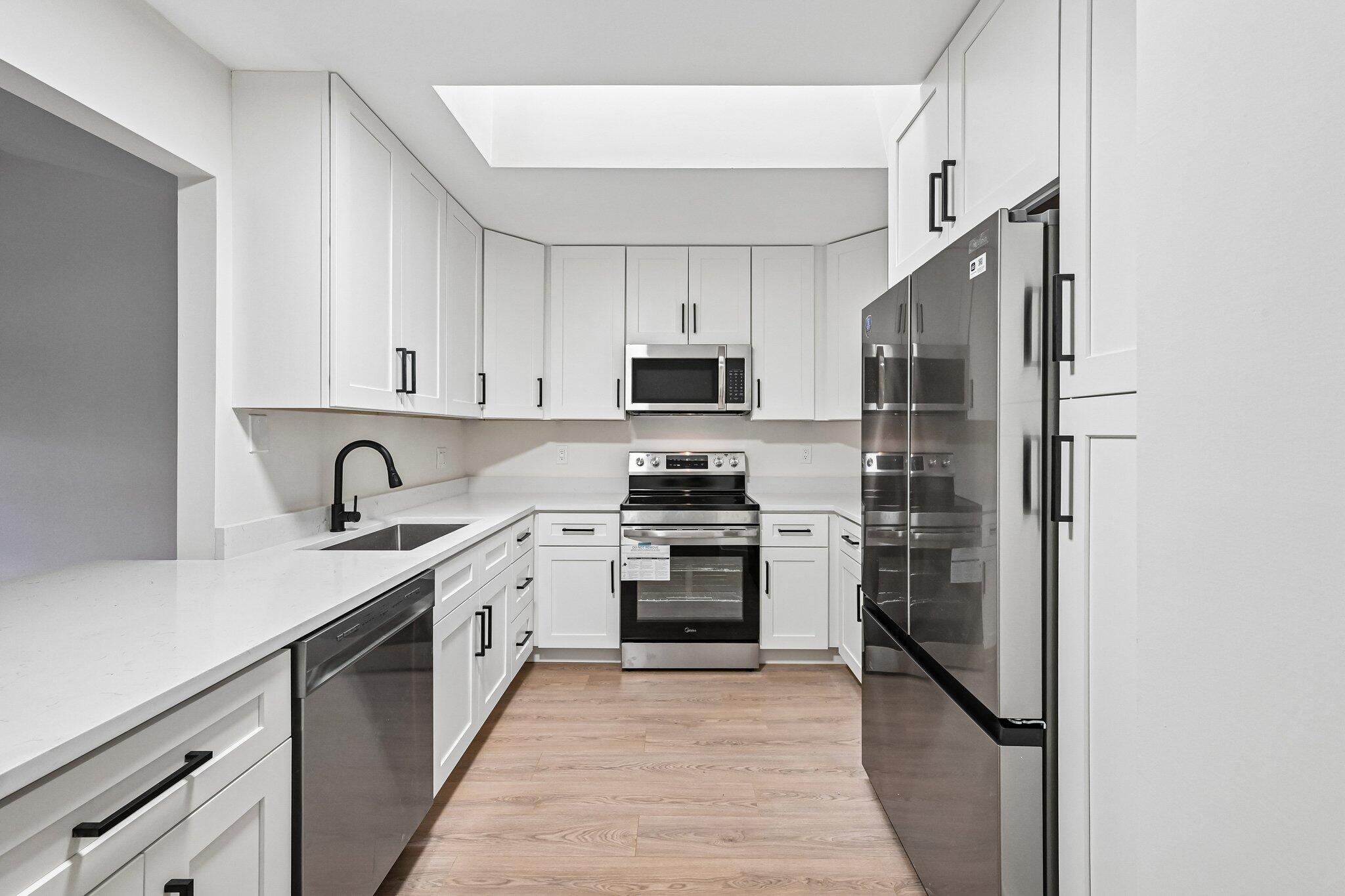 Welcome to this beautifully updated 2-bedroom, 2-bath villa featuring spacious rooms and soaring vaulted ceilings that create an open, airy feel throughout. Recent upgrades include new ceiling fans, modern light fixtures, stylish kitchen cabinetry, quartz countertops with a 4-inch backsplash, and a stunning waterfall-edge island. The kitchen is complemented by new stainless steel appliances, making it both functional and inviting. Enjoy the durability and contemporary look of waterproof, scratch-resistant laminate flooring throughout the home. The neutral interior provides a versatile backdrop, ready for your personal style and décor. This property offers flexibility with immediate rental eligibility, making it an attractive option for both owner-occupants and investors. Centrally​​‌​​​​‌​‌​​​‌‌​​​‌‌‌​​‌​​‌‌​​​​ located.