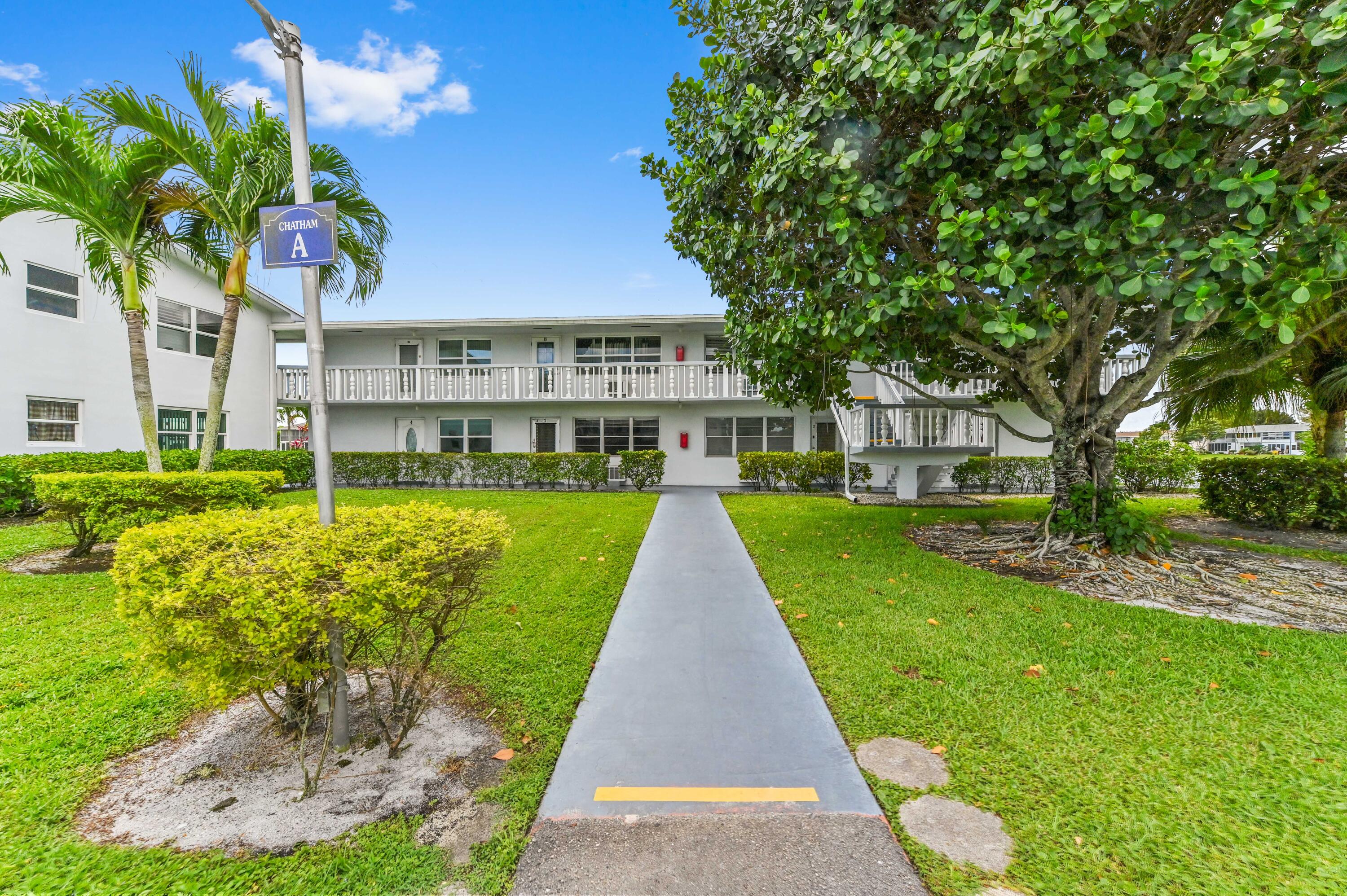 Welcome to Century Village Chatham Condominiums, a gated 55+ community offering comfort and serene waterfront living. This charming 2-story condo features a desirable corner, first-floor unit with 1 bedroom and 1.5 bathrooms, encompassing 684 sq ft of living space.  Step inside to a spacious dining and living area with carpeted flooring throughout, creating a warm and inviting atmosphere. The kitchen includes a convenient snack bar/counter, perfect for casual dining or entertaining. Enjoy peaceful mornings or relaxing evenings on the screened patio overlooking a beautiful lake view.  Ideal for those seeking a quiet, well-maintained community with scenic surroundings, this unit combines comfort, convenience, and picturesque waterfront living.
