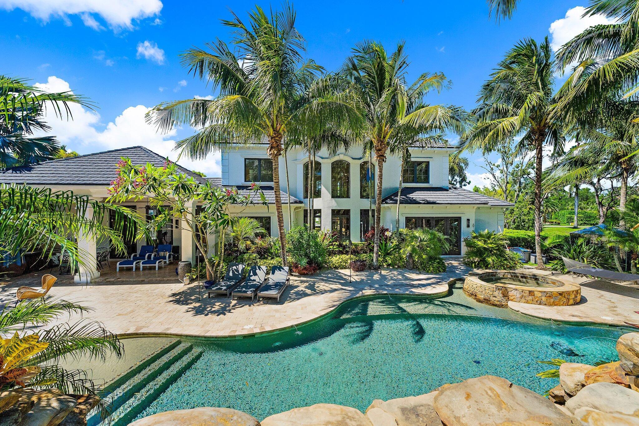 Live the resort lifestyle every day in this extraordinary custom estate in the gated community of Jupiter Equestrian Estates (Hidden Bridge). Set on a beautifully landscaped one-acre lot, this 5-bedroom, 5 full + 2 half bath home offers both luxury and comfort, with a thoughtful layout and incredible outdoor living spaces.

The primary suite is located on the main floor and features separate his-and-her toilets for added privacy. Upstairs, you'll find four generously sized bedrooms, each with its own en-suite bath, plus a large bonus room perfect for a media space, gym, or playroom. The custom-designed office and chef's kitchenâ”with double islands, gas stove, and Viking appliancesâ”make daily living and entertaining effortless. Step outside to your private tropical retreat with a lagoon-style pool, 20-foot slide, 12-foot waterfall, summer kitchen, and tranquil tiki hut sitting area. The entire yard is fully fenced and surrounded by lush landscaping, offering true serenity. Additional highlights include a whole-house generator, hurricane-impact windows and doors, and a 3-car garage.

Tucked away in an exclusive enclave of just 16 homes, this property is a rare opportunity to enjoy privacy, elegance, and the best of Jupiter living.