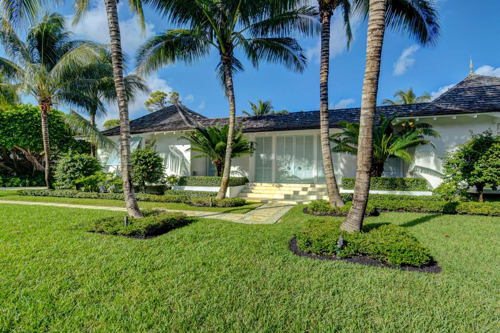One of the most architecturally interesting and pleasing homes in The Village of Golf. Inspired by the homes in The Tryall Club in Jamaica this house perfectly blends the outside with the inside resulting in Florida living at its very best. Wonderful golf course views of the 12th  green and 13th hole. The entrance is through large double louvre doors to a magical lanai with fountain, pool and a 2/2 Guest House with living room. You will not be disappointed except when it is time to go.