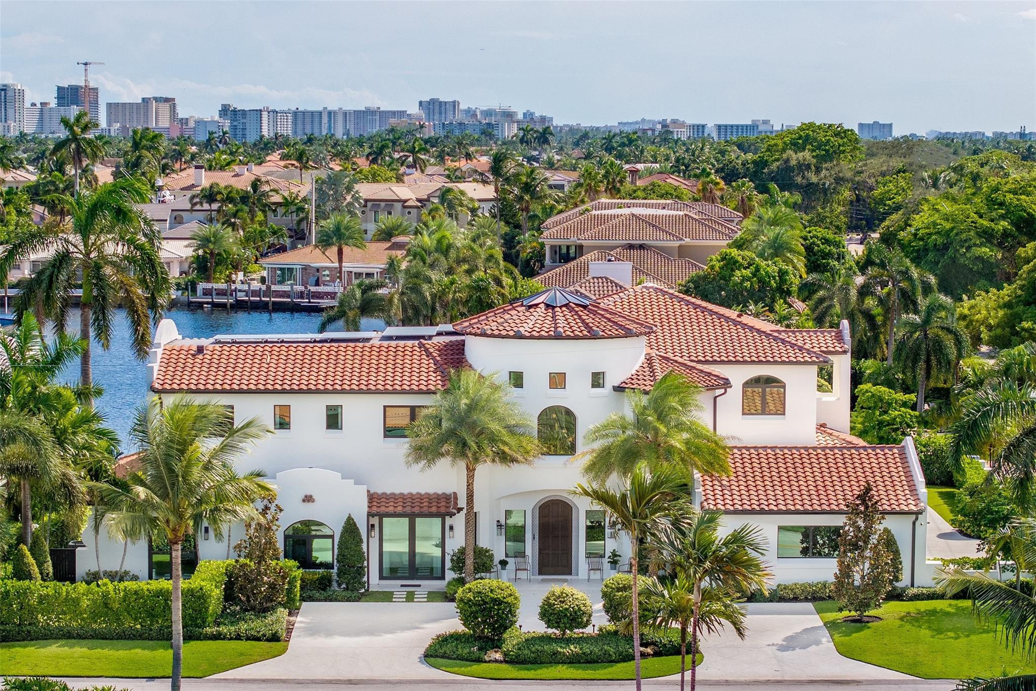 This 2022 one of a kind masterpiece is straight out of an architectural magazine designed by California designer, Lisa Mayock. This 8 bedroom, 7 full baths and 2 half bath estate is situated on an oversized corner lot with expansive water views. The home boasts all exotic natural stone, hard woods, custom fishes & skylight, Gaggenau/Sub-Zero/Meile appliances, & custom built-in dual control wine cooler. The home includes two fully equipped laundry rooms, a butlers pantry, pilates/gym studio, club room with wet bar, media room and office with private exterior access, and "mid-night" kitchen.  Exterior has cabana bath, outdoor shower, custom putting green, gated driveway with 4 car garage and EV chargers, full summer kitchen & retractable screens.  No fixed bridges, 10 mins to ocean.