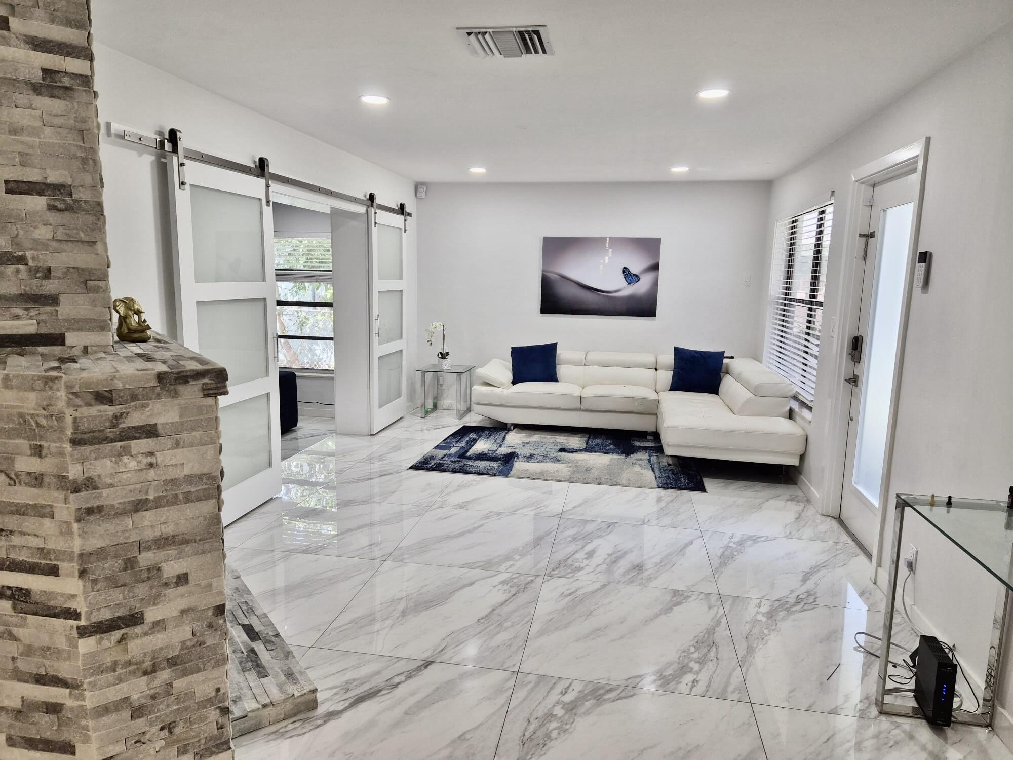 Beautifully remodeled West Palm Beach family home offering comfort, convenience, and energy efficiency. This spacious residence features 3 bedrooms plus a bonus room with a private entrance, ideal for a home office, guest space, studio, or retreat. Recent updates include a newer AC system, modern appliances, and solar panels designed to help reduce electricity costs and add long-term value. Located in a quiet neighborhood less than 1 mile from I-95, under 10 minutes from downtown West Palm Beach and the beach, and close to schools, daycares, shopping and entertainment. Fully renovated with flexible living spaces and a prime location, this home offers exceptional modern comfort and value.