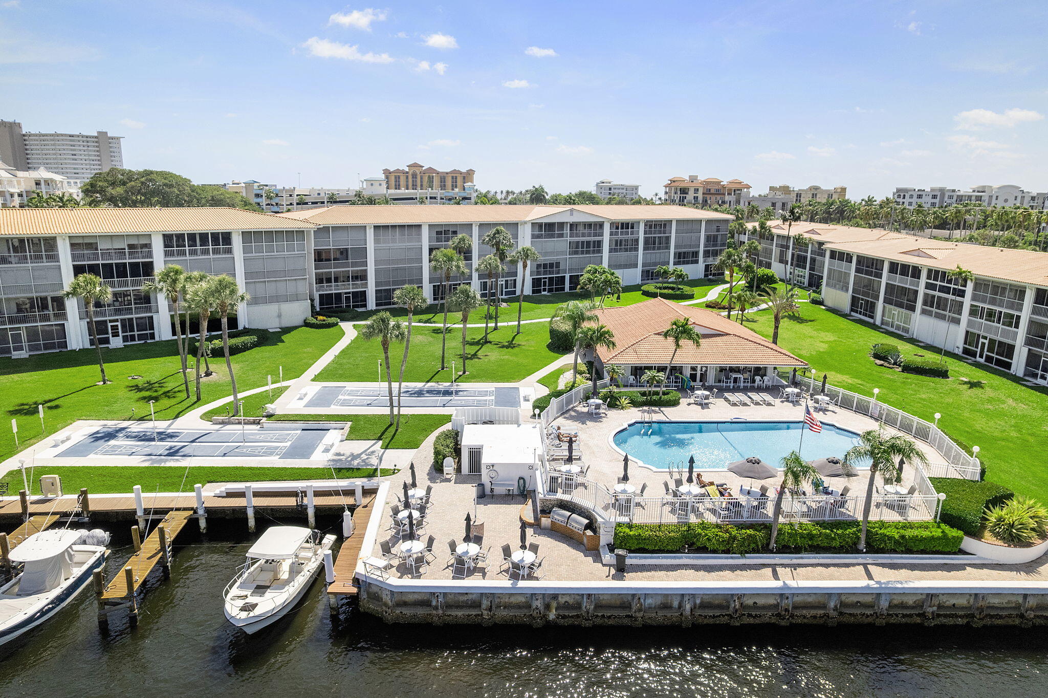 Live 2 blocks from the Pier and Boardwalk in Deerfield Beach. Enjoy the Intracoastal Waterway boating and views. This move in ready, fully furnished and updated 2-bedroom, 2-bath condo offers stunning views of the Hillsboro River and the sparkling Intracoastal Waterway. IMPACT WINDOWS THROUGHOUT and tiled flooring on diagonal. Enjoy serene water vistas right from your screened private balcony - perfect for morning coffee. ASSIGNED COVERED PARKING. Located in a friendly, active adult community, this home is just a short 1000 step stroll to the beach, making every day feel like a vacation. The vibrant heart of Deerfield Beach is 2 blocks away, offering charming shops, delicious dining, and lively entertainment.  Walk to the Cove and enjoy many great restaurants and shopping!