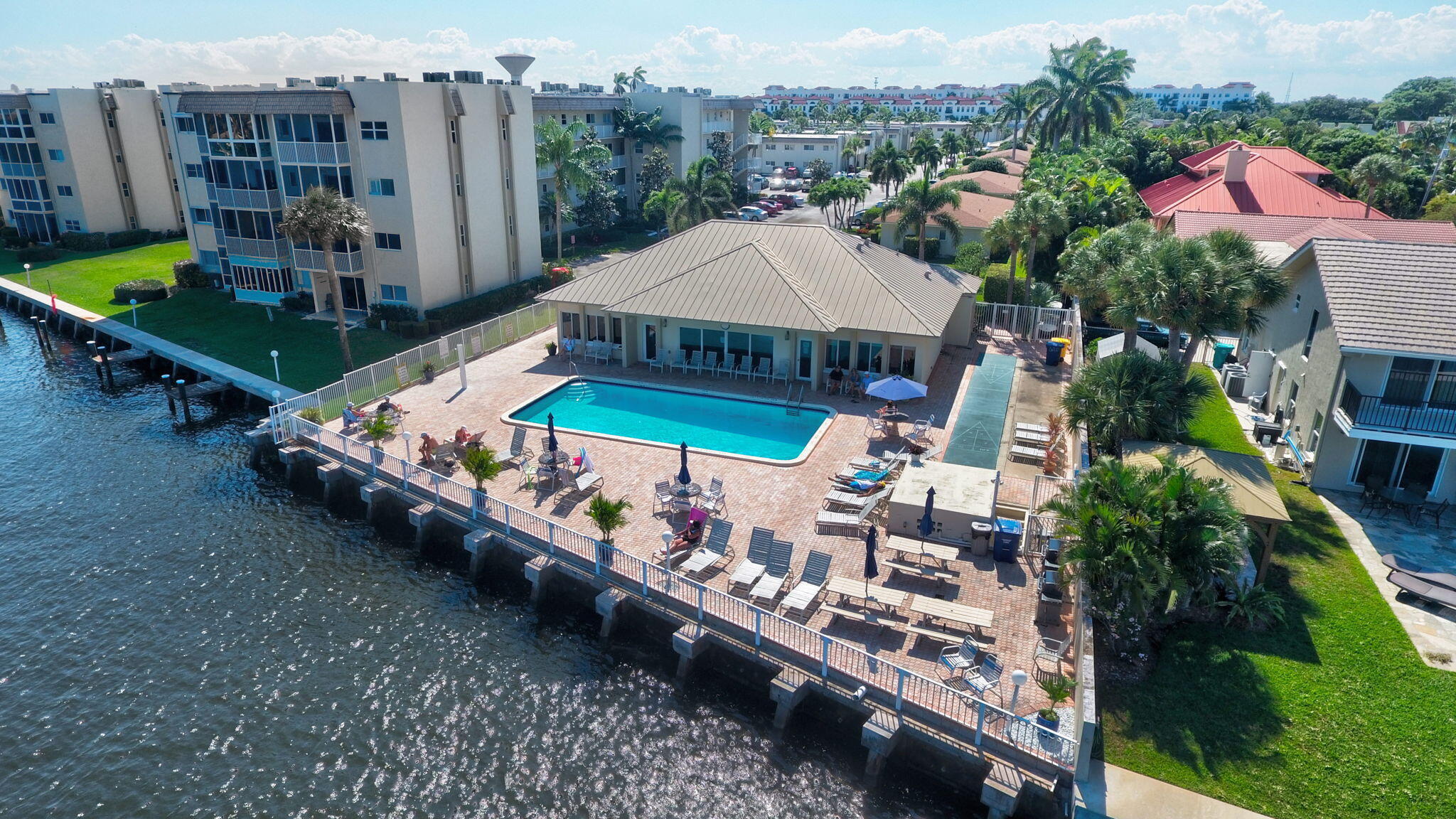 Welcome to Snug Harbor! This cozy smaller 55+ waterfront community is a popular choice. Come see this well-kept 2 bed 2 bath with a fabulously updated kitchen featuring blue coastal accents. This all tile condo is delivered unfurnished with a newer AC, water heater, and electrical components including lighting, switches and sockets. Easy to own and care free. The star of the show is the extra large lounge-ready front screened porch that Snug Harbor is famous for. While out about you'll find shopping and dining within walking distance. When at home visit the intra-coastal front pool to relax and watch the boats pass by. Schedule a showing today!