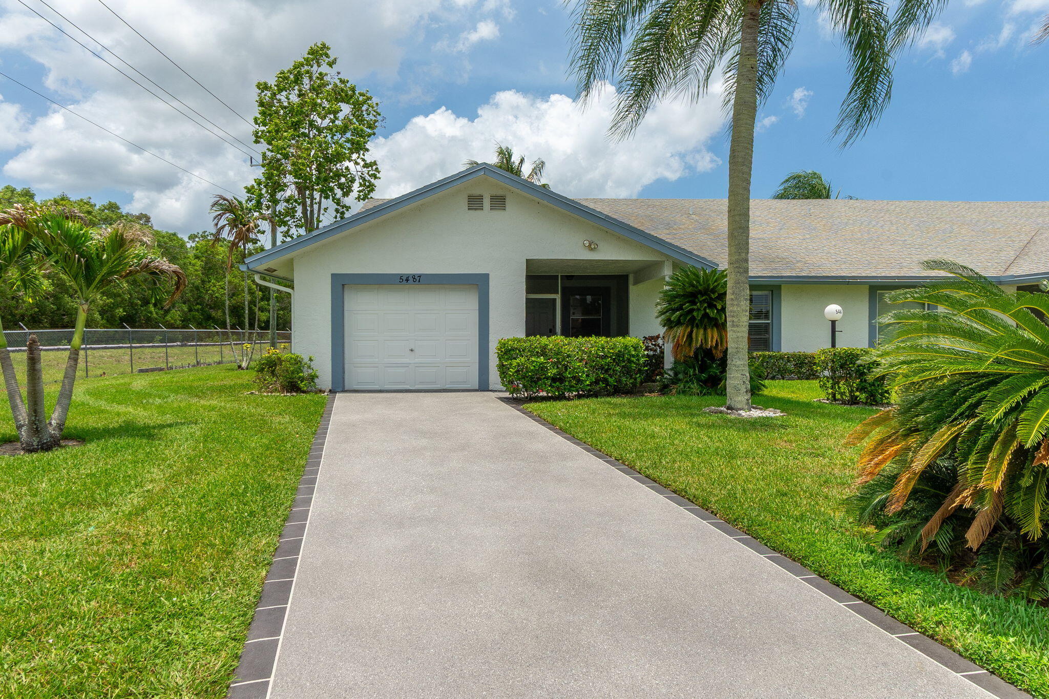 Welcome to this beautifully updated, fully furnished, turn-key 3-bedroom, 2-bath villa located in the highly desirable 55+ community of Cypress Lakes. Perfectly positioned in one of the community's most peaceful settings, this move-in-ready home combines modern upgrades with relaxed Florida resort-style living. The renovated kitchen features granite countertops, a large center island, and excellent functionality for everyday living or entertaining. Both bathrooms have been thoughtfully updated with a clean, modern finish, and the driveway has been newly completed for a fresh, polished exterior appeal.  The enclosed Florida room serves as a bright, flexible living space designed for seamless indoor-outdoor enjoyment.   Expansive hurricane-impact sliding glass doors open to tranquil views of the golf course and surrounding greenery, creating a calm and private natural backdrop. Premium Levolor In-Motion motorized shades allow effortless control of light, privacy, and ambiance throughout the day. Set directly along the golf course, the home offers a serene lifestyle framed by open fairway views—ideal for morning coffee, quiet afternoons, or entertaining guests in a peaceful environment.  Residents of Cypress Lakes enjoy true resort-style living with one of the lowest HOA fees in the area. Amenities include an 18-hole golf course, clubhouse with active social calendar, swimming pool, jacuzzi, sauna, fitness center, billiards, ping-pong, tennis, pickleball, shuffleboard, and mini golf. The HOA provides exceptional value by covering high-speed internet, cable, lawn care, and 24-hour gated security. In this section, exterior painting is also included, providing a low-maintenance, carefree Florida lifestyle. This is a rare opportunity to own a fully furnished, upgraded golf-course villa in a well-established, amenity-rich community. Move in and immediately enjoy comfort, convenience, and lifestyle—all in one.