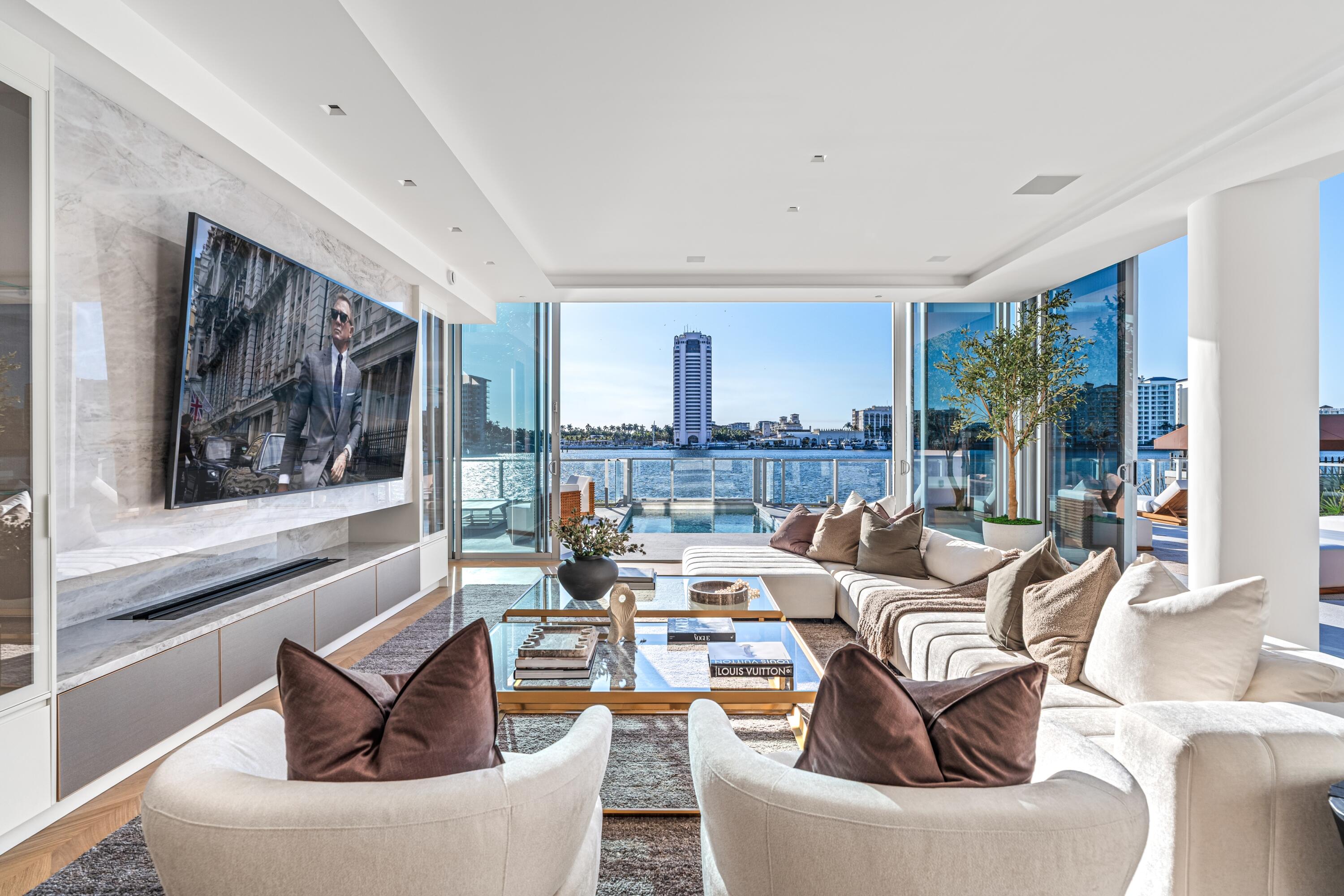 Floor-to-ceiling glass captures unobstructed lakefront views of the The Boca Raton resort in light-filled interiors that possess the scale, privacy and ease of a single-family home, complete with private dockage and direct inlet access. Flawless in its every aspect, this rare lifestyle opportunity combines understated luxury, privacy and prestige with the ultimate in secure lifestyle ease. Just completed in 2026, this pristine modern contemporary residence was artfully designed by renowned Sieger Suarez Architects; with interior flair by designer Linda Ruderman; and artfully landscaped grounds by internationally acclaimed Raymond Jungles, Inc. Newly reconfigured and enhanced, it is seamless in design and lifestyle, offering the unique marriage of an ultraluxury waterfront single-family residence with the lock and leave security, convenience and amenities of an exclusive resort-style condominium. Exceptionally Notable: the incomparable lake and sunset views; private pool and summer kitchen; elevated ceiling height, higher than all other floors in the building; white oak chevron plank wood flooring; Phillip Jeffries wall coverings; Savant Smart Home Management System; dual offices; ultra-sleek gourmet kitchen with Cristallo quartzite countertops, Dell Anno cabinetry, top-tier Gaggenau appliances, custom under-counter lighting, built-in casual dining, and a wine refrigerator; a fluted wood family room accent wall; primary spa-inspired bathroom with book matched Calacatta marble shower; unprecedented storage; private air conditioned two-car garage with extra storage; direct access to the Boca Raton Resort Beach Club.  Location 725 South Ocean Boulevard, Boca Raton, Florida. This ultra-private first floor corner residence is ensconced in the exclusive Boca Beach Residences, a four-story, 32-unit condominium enclave on 3.2± acres fronting Lake Boca Raton. This particular residence is ideally situated near the state-of-the-art fitness center (complete with sauna, massage and steam) and a private entrance with direct street access. It is 50'± from its own private boat dock, offering direct Intracoastal and ocean access with no fixed bridges. All in close proximity to world-class shopping and dining in Mizner Park, and Boca Raton's private executive airport.  Property This magnificent property assures privacy, security and convenience with a 24-hour doorman and lobby concierge desk. Residents enjoy a private walkway to The Boca Raton Beach Club, a massive sun-splashed infinity-edge pool with sun shelf and resort loungers, separate soaking spa, a covered lounge with built-in grilling station, fitness center, assigned temperature controlled storage unit, EV car charging stations, valet parking, a lakefront boardwalk, even cold storage for perishable deliveries.   This unique residence also features: its own private 2.5 bay remote-controlled air-conditioned garage within the building garage, a private full service yacht dock, heated pool, private grilling station for alfresco waterside dining, and a private entertaining oasis with its unique side terrace.    Residence Complementing its exceptional setting, this Lake Boca Raton jewel is truly a study in light and space. Guests arrive through a double door entry foyer dividing the east and west wings. The west wing is comprised of a light-infused great room and secluded lakefront primary suite. The great room encompasses: floor-to-ceiling lake views; a living room area with massive flat screen and speakers, linear Aquafire water vapor electric fireplace, sliders to pool and dock; dining area with hidden built-in bar; casual dining supported by a magnificent chef's gourmet island kitchen. An unobtrusive door in the living area provides access to a primary suite with expansive lakefront bedroom, custom-fitted his/hers walk-in closet on the scale of a small boutique, designer spa-inspired bath with separate vanities and water closets and a glass-enclosed double shower.   The east wing includes: his office with detailed tray ceilings and custom built-ins, separated from her office by two guest suites with boutique walk-in closets, all opening to a private terrace. A third guest suite also offers stunning bath detail and a custom-fitted walk-in closet. A family room with fluted accent wall is accessible from a gallery hallway with multiple closets, a powder room, and hidden walk-in pantry. The oversize laundry with double washers and dryers and a private garage elevator complete the residence.  Other Special Features:  Savant smart home technology, Sonos sound Lutron lighting and shades, custom moldings/cabinetry/built-ins/boutique closets/recessed lighting/tray ceilings/wall treatments/speaker system, Waterworks fixtures, Toto toilets, three HVAC units, linear diffusers.  Staging and furnishings by Vesta Home; all furniture available for purchase.      DISCLAIMER: Information published or otherwise provided by the listing company and its representatives including but not limited to prices, measurements, square footages, lot sizes, calculations, statistics, and videos are deemed reliable but are not guaranteed and are subject to errors, omissions or changes without notice. All such information should be independently verified by any prospective purchaser or seller. Parties should perform their own due diligence to verify such information prior to a sale or listing. Listing company expressly disclaims any warranty or representation regarding such information. Prices published are either list price, sold price, and/or last asking price. The listing company participates in the Multiple Listing Service and IDX. The properties published as listed and sold are not necessarily exclusive to listing company and may be listed or have sold with other members of the Multiple Listing Service. Transactions where listing company represented both buyers and sellers are calculated as two sales. "No payments made until title passes" Some affiliations may not be applicable to certain geographic areas. If your property is currently listed with another broker, please disregard any solicitation for services. Information published or otherwise provided by seller, listing company or its representatives is deemed reliable but are not guaranteed and subject to errors, omissions, or changes without notice. Copyright 2026 by the listing company. All Rights Reserved.