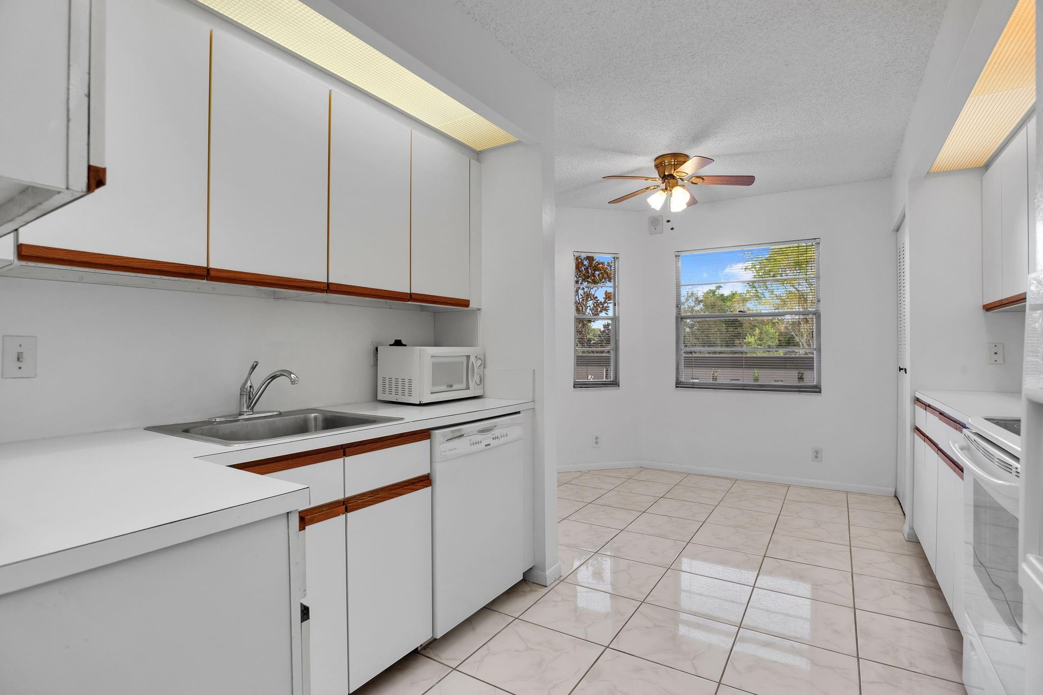 This property is in pristine condition. The kitchen features an extra-large pantry and two windows that bring in natural light. It includes a glass-top stove and a newer dishwasher, and it has been professionally painted and cleaned. There is an interior washer and dryer, and a solid front door. The carpet can be easily replaced or removed without damaging the tile underneath. The second bedroom has a sliding glass door to the closet, allowing it to accommodate a king-sized bedroom set. The Patio features a floor-to-ceiling jalousie glass enclosure. Additionally, the air conditioning system was updated in 2018. It's just a short walk to the Cayman pool, the main pool, the fitness center, and the theater. SEE ALL PHOTOS THEN SEE FOR YOURSELF *HEATED SWIMMING POOL*WYNMOOR COUNTRY CLUB FEATURES: IN HOUSE MOVIES & LIVE SHOWS ON SATURDAY NIGHTS WITH DANCING AFTERWARDS IN THE WEST WING OF THEATRE*18 HOLE EXECUTIVE GOLF COURSE.*TENNIS/PICKLEBALL COURTS, BOCCE COURTS, STAINED GLASS, CERAMICS, POTTERY, ART STUDIO, GLASS KILN, ZUMBA & WATER AEROBIC CLASSES, BILLIARD/POOL CENTER WITH HEATED BILLIARD TABLES, PING PONG, SAUNA, RESISTANCE WALKING POOL*SHUTTLE BUS SERVICE*OVER 90 CLUBS TO MEET NEW FRIENDS*962 THEATRE WITH DOLBE SOUND SYSTEM COFFEE SHOP REST. WYNMOOR IS LIKE A 'SLEEP AWAY CAMP FOR SENIORS" 55+.