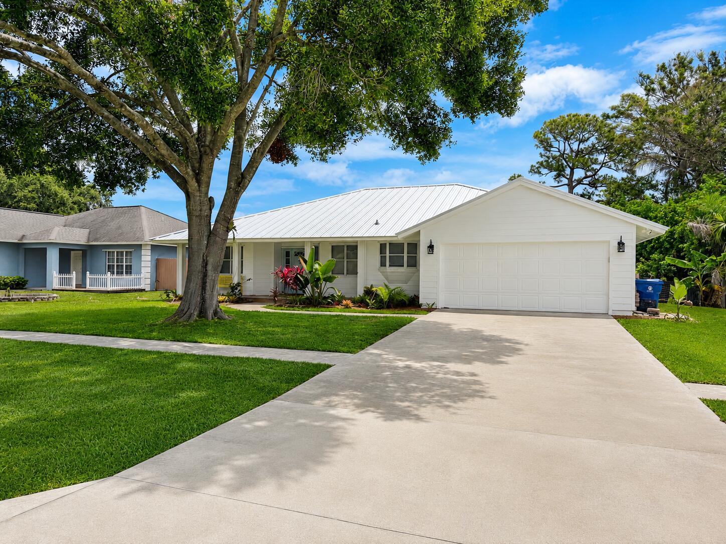 Tucked away on a private corner lot in the heart of Jupiter, this beautifully updated Key West-style home offers the perfect blend of privacy, charm, and coastal convenience. Backing up to a peaceful nature preserve with no HOA restrictions, this property gives you the freedom to bring your boat, RV, pets, and toys while enjoying one of Jupiter's most desirable lifestyles. This 3-bedroom, 2-bath home with a 2-car garage features an inviting open-concept layout designed for comfortable everyday living and easy entertaining. Inside, you'll find new wood-look vinyl flooring throughout, updated lighting with high hats, and a fresh, cohesive feel from room to room. The renovated kitchen serves as the heart of the home, complete with a center island, all-new appliances, and stunning Taj Mahal  quartzite countertops. Both bathrooms have been tastefully updated, offering a clean coastal feel. Major improvements add peace of mind, including a new roof, new hot water heater, new hurricane impact shutters, and new Hardie board plank siding. Outside, the spacious lot offers privacy, room to enjoy the outdoors, and a serene backdrop with the preserve behind the home. Ideally located just minutes from Jupiter's beautiful beaches, boat ramps, waterfront dining, shopping, and local favorites, this move-in-ready home is a rare opportunity to enjoy privacy, updates, and true Jupiter living without HOA limitations.