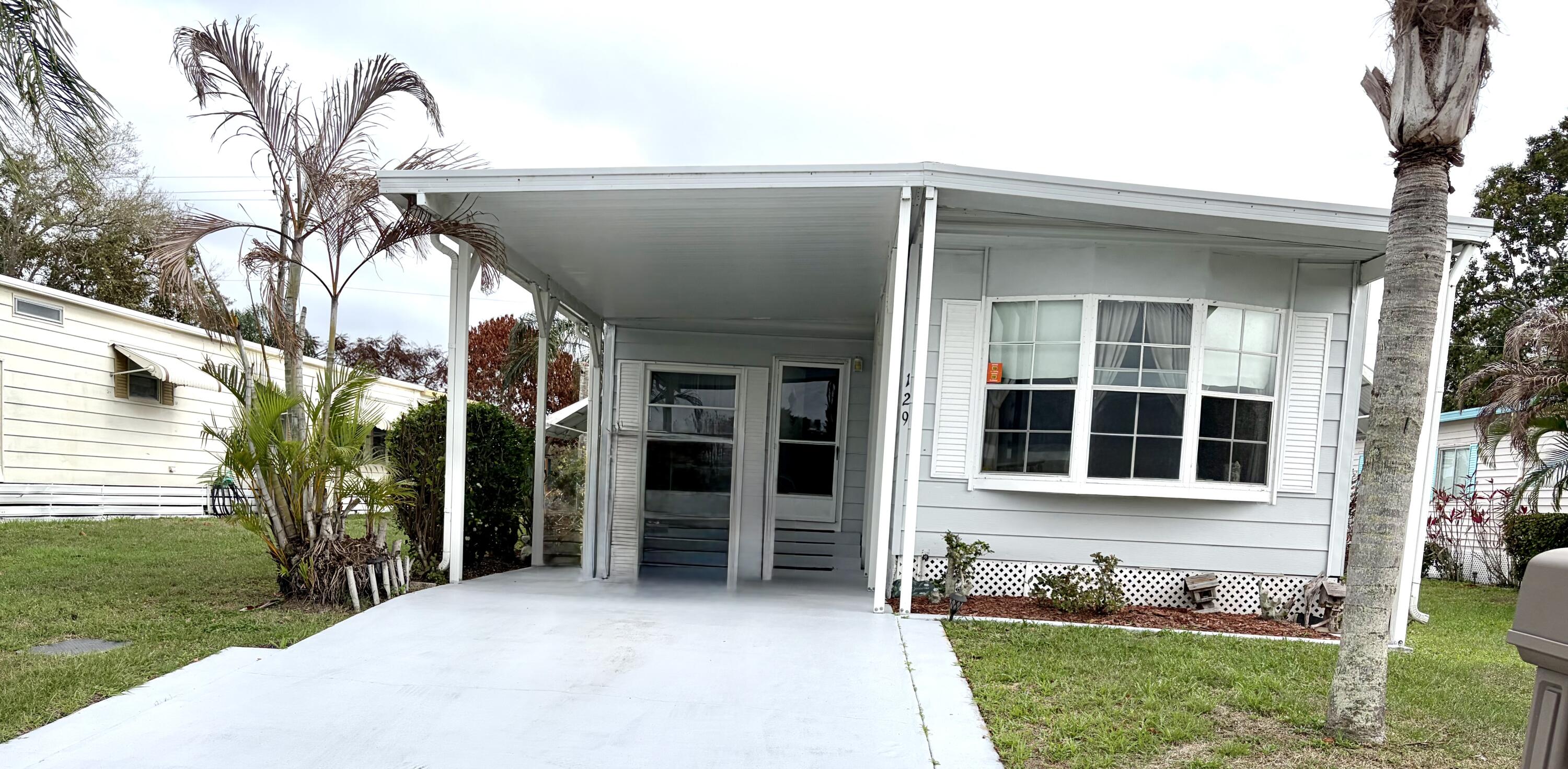 Settle in here at 129 East Caribbean located in a great 55+ community with active and energetic residents. Lot's of golf, fishing, shopping, boating, music, churches, dining, theater, sports and car shows all you can do! This 2 bedroom split layout gives access to privacy when guest arrive with 2 separate baths and a large Florida room you'll have plenty of space. There is a good work room (can be a studio) and separate indoor laundry and storage. There is carpet clean without too much wear and the private suite in the master (NEW SUBFLOOR) does need finish with buyers choice. Outside your Florida room you'll enjoy hours of soaking up nature and cooking up a nice steak on the grill with the view of open field (cannot be built on). Nicely landscaped and easy maintenance. COME SEE! BONUS!! Hot water on demand with this well-maintained home! Land leased (977 monthly) in Spanish Lakes 55+ community includes mowing, trash recycle, GOLF, use of clubhouse pool tennis pickle ball and gym, library, with many activities like dinners, dances, cards, and meeting great friends! Close to beaches, shopping, hospital, dining, music, sports, fishing and more. Resort style living at it's best! .
