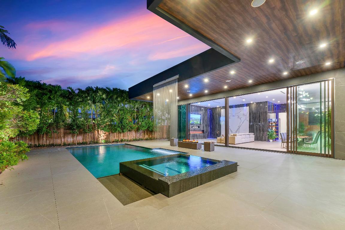 Welcome to the ultimate East Fort Lauderdale gem. This gated estate sits on an oversized lot within close proximity to the intracoastal & beach. This expansive ranch-style home, built by the renowned Prestige Homes, features an ultra-sleek design with meticulous detail and top-tier finishes throughout; completed with imported porcelain tile, bookmatched wall slabs, premium lighting, and a fully integrated Smart Home. The chef's kitchen shines with Sub-Zero appliances, and the spacious open floor plan is complemented by high ceilings and oversized custom doors. This home consists of five bedrooms, six bathrooms, an office, plus a large finished attic/storage room under A/C. Complete smart home featuring smart lighting, A/C, music, pool, gates, security cameras, and a fully finished garage that is fully air-conditioned with room for up to 4 cars. Fully expansive smart pool and spa with an enchanting waterfall. This home is gated and private as well as a High-efficiency Trane A/C. Nearby conveniences include amazing restaurants, shops, parks, and beaches, schools, etc.   Homes like this do not stay on the market for long. Schedule your viewing now!  Also Available for Lease or Lease-Purchase for Future Ownership. Inquire for Details.
