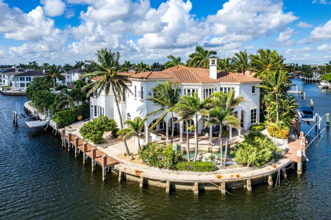 Direct intracoastal waterfront jewel located on point lot featuring dramatic waterway views throughout, 5 bedrooms and 6 full bathrooms, master suite with workout room/office, a two-story rotunda, impact windows/doors, custom kitchen, wet bar, wood panel study, equipped with elevator, and a 3-car garage.  First floor boasts a unique open floor plan that lends itself to entertaining with separate service staircase.  Exterior features include custom beach entry style pool with spill over jacuzzi, and expansive rear patio with an impressive 175 feet of water frontage and 80 feet of dockage.