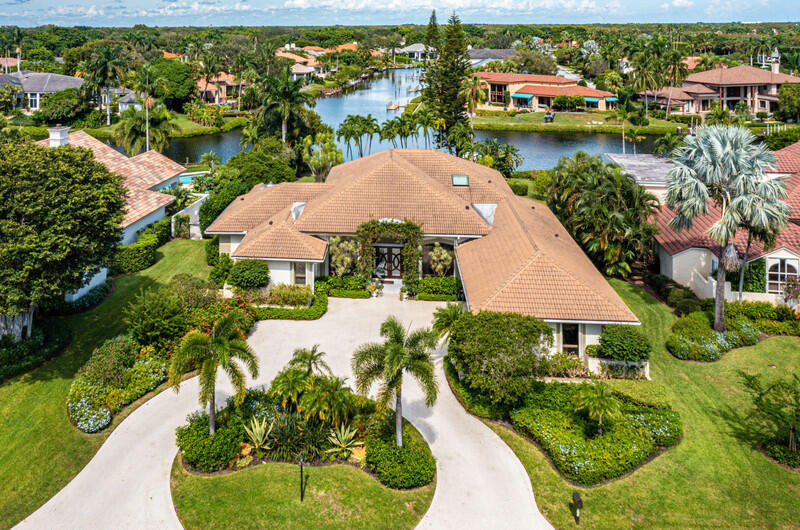 Long and panoramic interior waterway views with private dock for impressive estate offering 3BR with possible 4th BR with office conversion.  Spacious Florida room, 4 full and 1 half bath with ample living space edged in windows framing tranquil tropical views.  Travertine flooring, soaring ceilings, electric shades, oversized wetbar with wine cooler and ice maker, separate spacious dining area and 2 car newly-pattern epoxied garage with additional golf cart storage. Ideal kitchen featuring abundant wood cabinetry, Quartzite counters, double stainless steel ovens, concealed refrigerator and counter seating. Well-appointed bedrooms with primary suite offering Florida room access, oversized bath with dual vanities and dual water closets plus separate steam shower. Primary suite also features his and her generous tailored walk-in closets. Private office off primary suite easily converted into a 4th bedroom with full bath. Outdoor oasis offers gorgeous views, electric retractable awning with lighting, outdoor grill, heated pool and raised Jacuzzi with water feature and Aquilink control pad in living room. A boaters paradise with enhanced impressive dock complete with power lift for 45 ft boat and quick deep water access.
