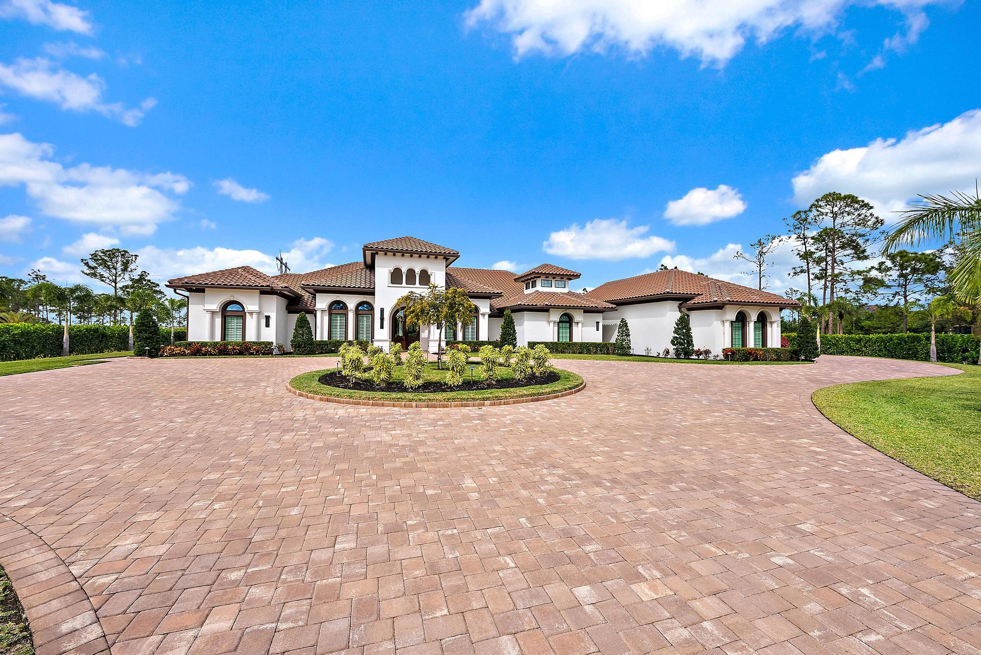 Located within Sabal Creek at PGA Village—an exclusive enclave of only 139 residences—this extraordinary, irreplaceable custom estate offers a level of privacy, scale, and lifestyle that cannot be recreated at this price point. PGA Village - Port St. Lucie is consistently ranked among the Top 75 Best Golf Resorts in the World by Golf Digest, making it a sought-after setting for professional athletes, celebrities, and high-networth individuals. Set on just under five acres and bordered by a protected Audubon Society preserve, the property delivers exceptional seclusion, breathtaking natural surroundings, and the space to live, train, and entertain at the highest level.  The expansive open-concept floor plan is enhanced by full Control4 smart-home technology, seamlessly managing lighting, audio, and automated window treatments throughout.  The chef's kitchen is a showpiece, featuring a Sub-Zero refrigerator/freezer, Wolf 6-burner gas range, double ovens, and an oversized center island well suited for both everyday living and entertaining. Additional interior highlights include a custom home theater with a dramatic shooting-star ceiling and a private, fully equipped home gym.  Outdoors, the estate functions as a private resort. The backyard includes a large resort-style pool with lazy river, spa, sunken fire pit, fire bowls, waterfalls, tiki bar, and a full outdoor sound system. Situated on 4.5 landscaped acres, the property also offers a football/baseball field, trampoline, and concrete corn hole court, providing a wide range of recreational amenities.  A rare offering combining expansive acreage, privacy, and resort-caliber amenities within one of Florida's most recognized golf destinations.  Being Sold Furnished (some exclusions apply)