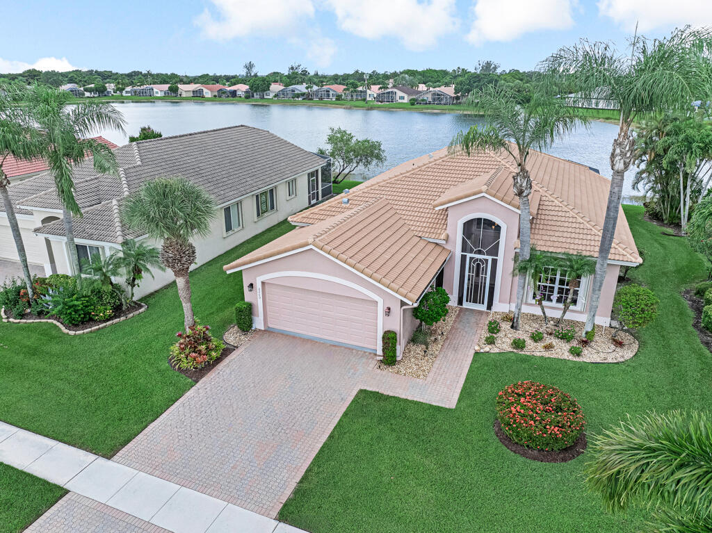 ALMOST NEW ROOF ! ONE OF A KIND LOCATION! Spectacular lakefront living awaits! This beautifully maintained 3-bedroom, 2-bath home is perfectly situated on the largest lake in the community, offering breathtaking wide-water views. The stunning kitchen was completely remodeled just 3 years ago and is the centerpiece of the home. Features include plantation shutters, crown molding, granite countertops in both bathrooms, new shower doors, a Jacuzzi tub, and custom closet organizers. Enjoy the magnificent lake views from the expanded screened patio. Additional updates include a roof just 6 years old, 7-year-old A/C, and a 2015 water heater. Ideally located just steps from the community's spectacular newly renovated clubhouse!