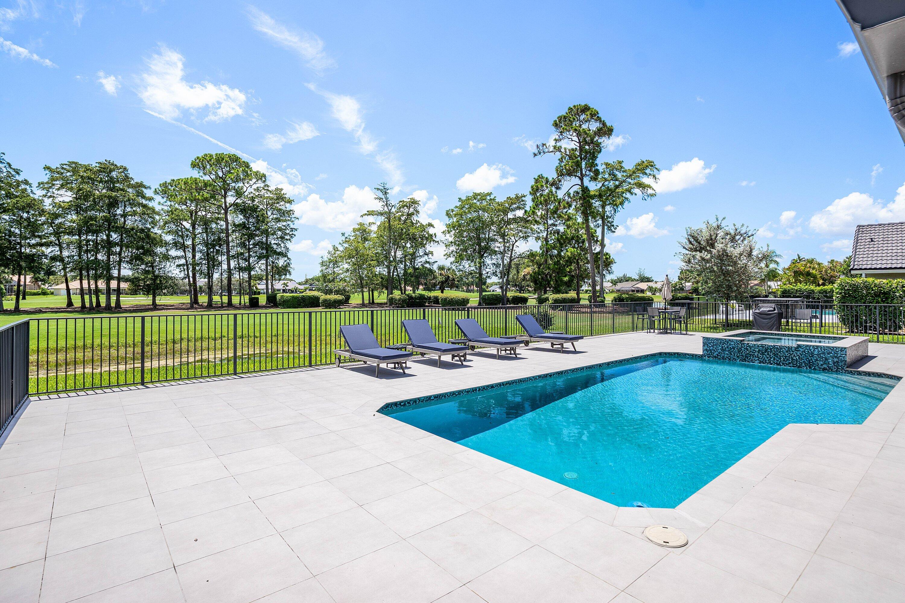 Perfectly positioned in the heart of Boca Woods Country Club, this beautifully situated 3 bedroom, 2.5 bath home boasts panoramic golf course and water views. The bright, open floor plan features, a spacious kitchen with a breakfast area and a luxurious primary suite with a custom walk-in closet, frameless glass shower and direct access to the pool. Additional highlights include 2021 roof, hurricane-impact front & garage door, and a 2-car garage plus a golf cart garage. Boca Woods is an all age Country Club Community which offers resort style amenities, including two championship golf courses, Har Tru tennis courts, pickleball courts, state of the art fitness center, spa, game room, fully renovated clubhouse with fine dining and much more! Mandatory Country Club membership $150,000.