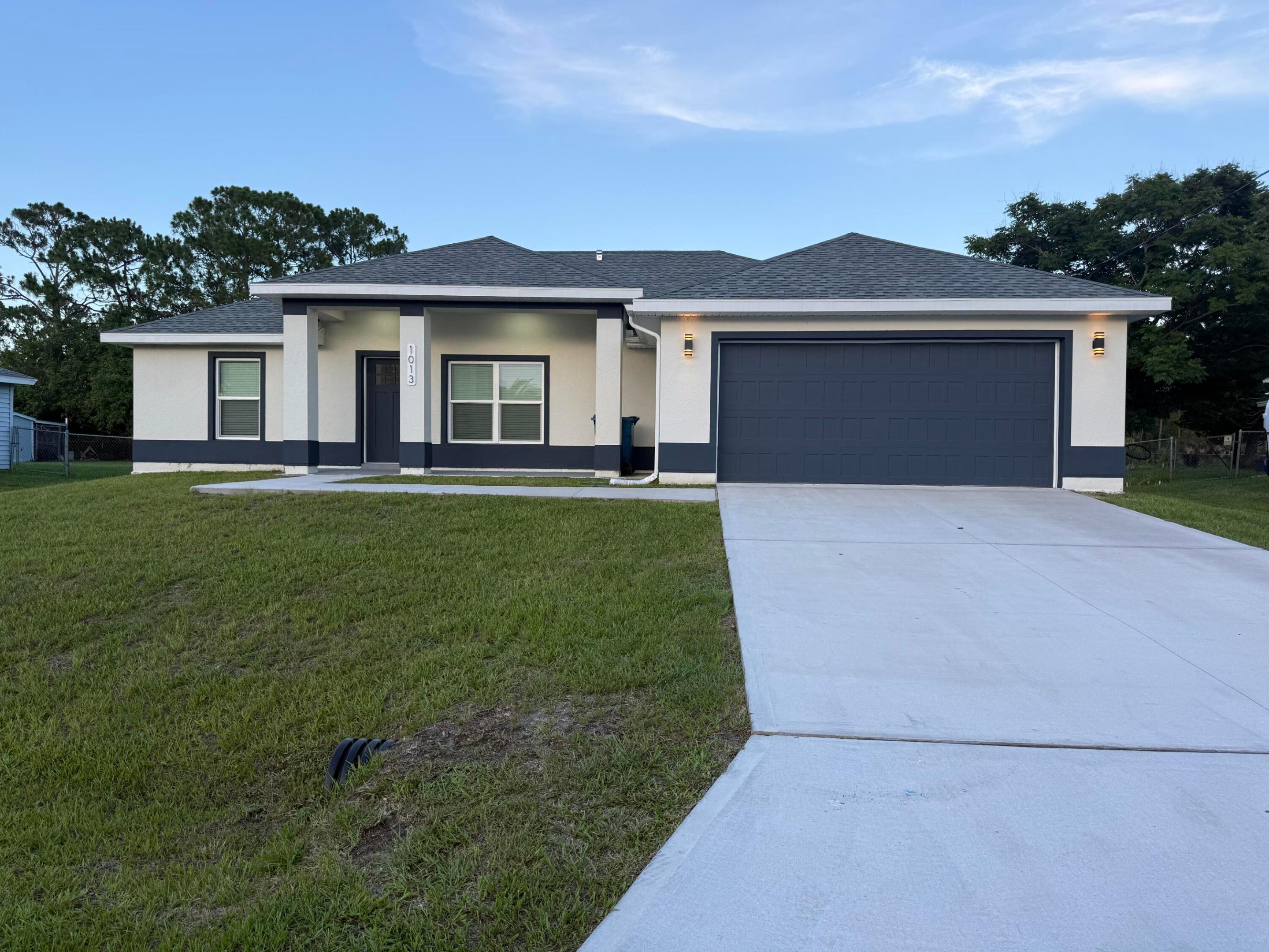 Custom-Built in 2025! This beautifully designed 3-bedroom, 2-bath home offers a desirable split floor plan with quality finishes throughout. Featuring tile flooring throughout the entire home, this move-in-ready property combines modern style with low-maintenance living. The spacious kitchen is complete with contemporary finishes, ample cabinet space, and an open layout overlooking the main living area, making it ideal for both everyday living and entertaining. The primary suite features a relaxing soaking tub, separate shower, and generous closet space. Enjoy the Florida lifestyle from the screened rear porch overlooking a private canal, providing added privacy with no rear neighbors. The oversized, fully fenced backyard offers plenty of space for pets and outdoor activities!